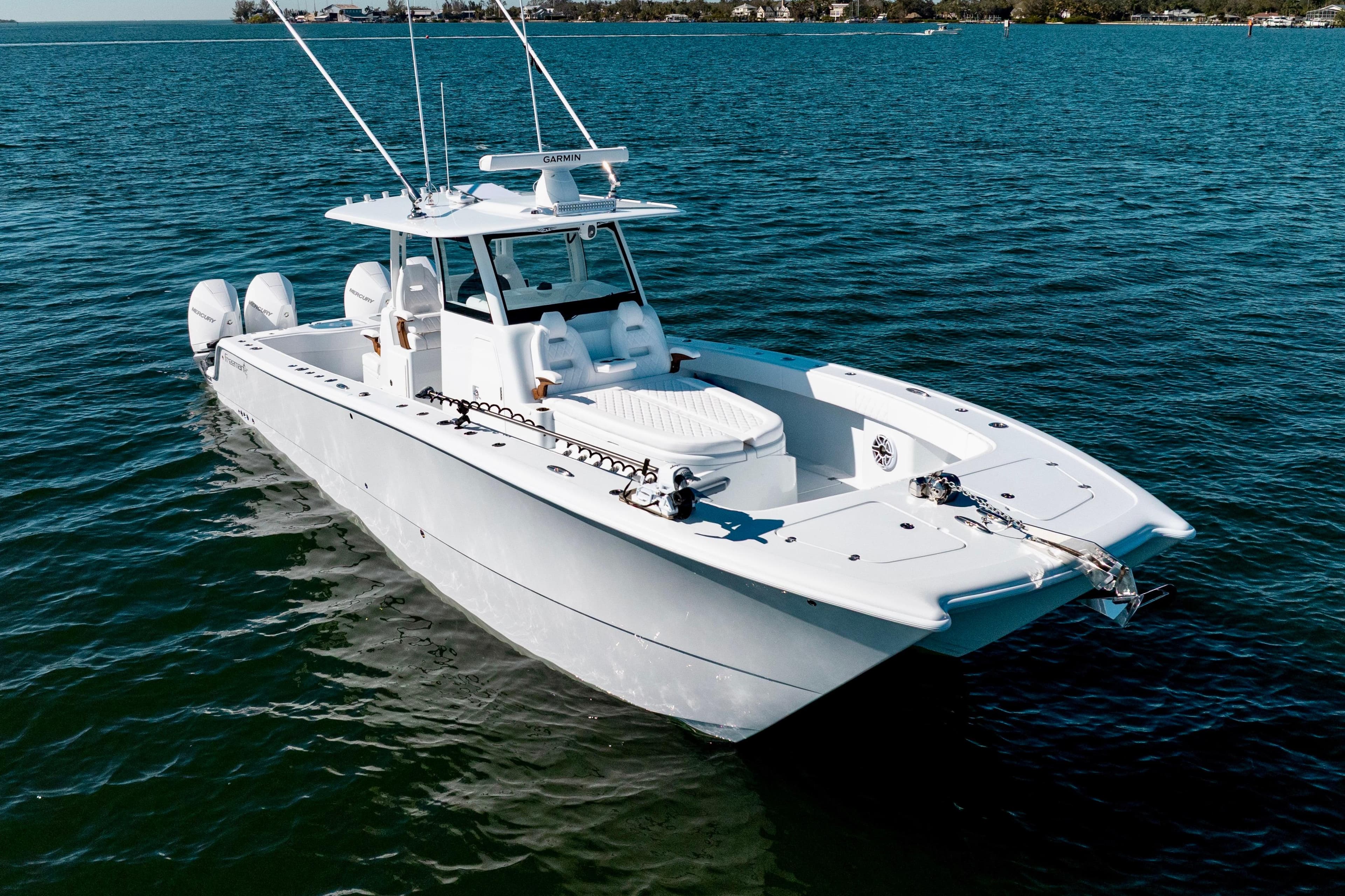 2026 Freeman 35 boat on calm blue water, featuring twin engines and sleek design.