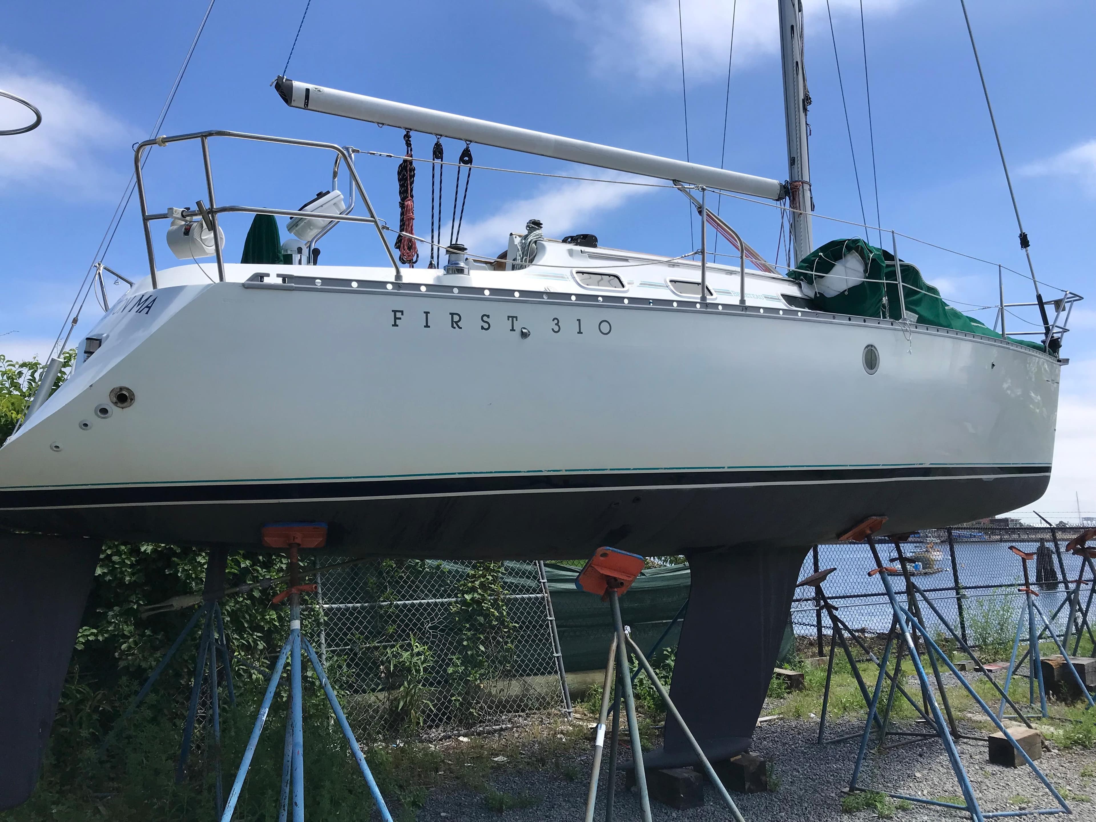 1993 Beneteau First 310 sailboat on stands, ready for maintenance.