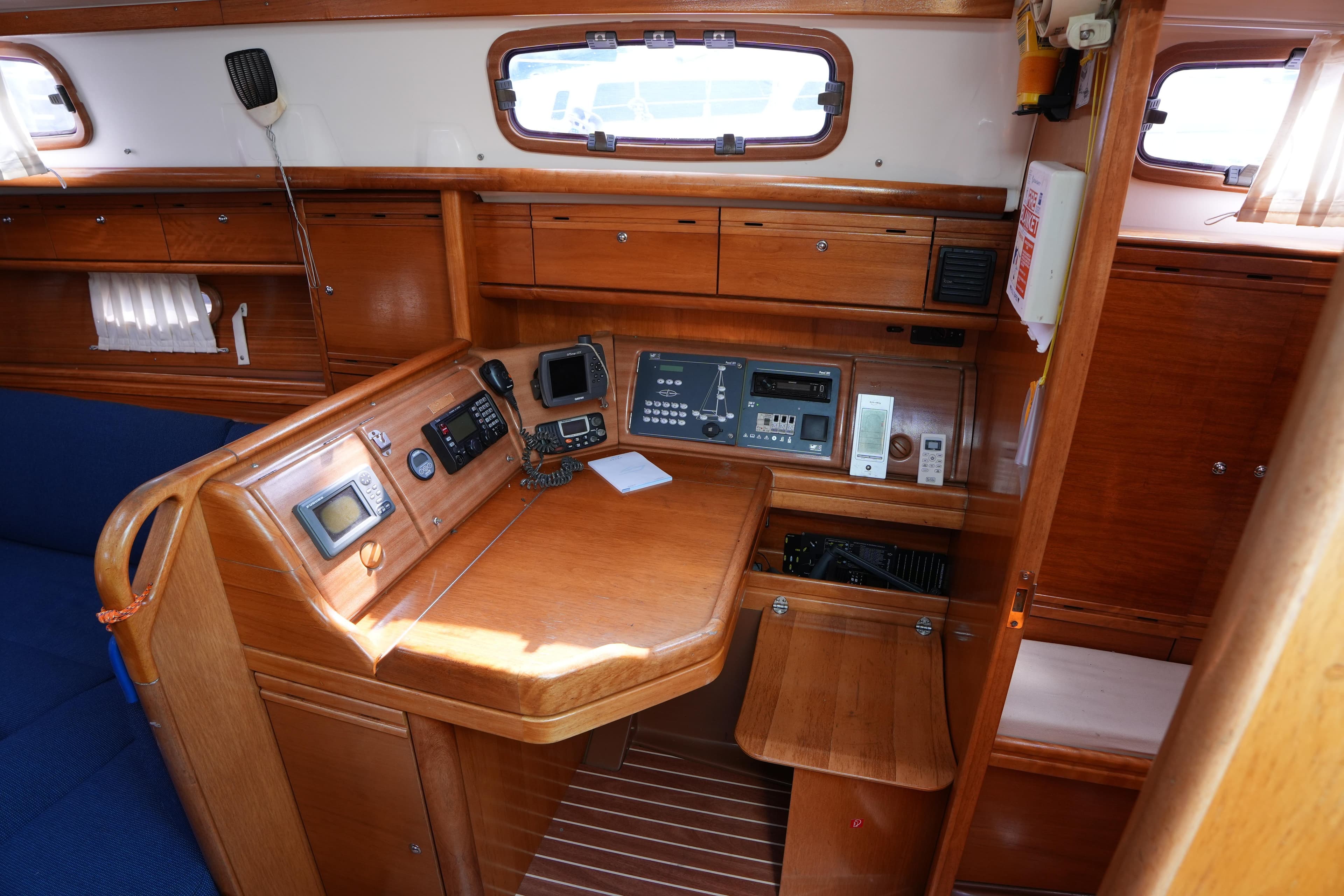 2007 Bavaria 37 C yacht interior with navigation equipment and wooden cabinetry.