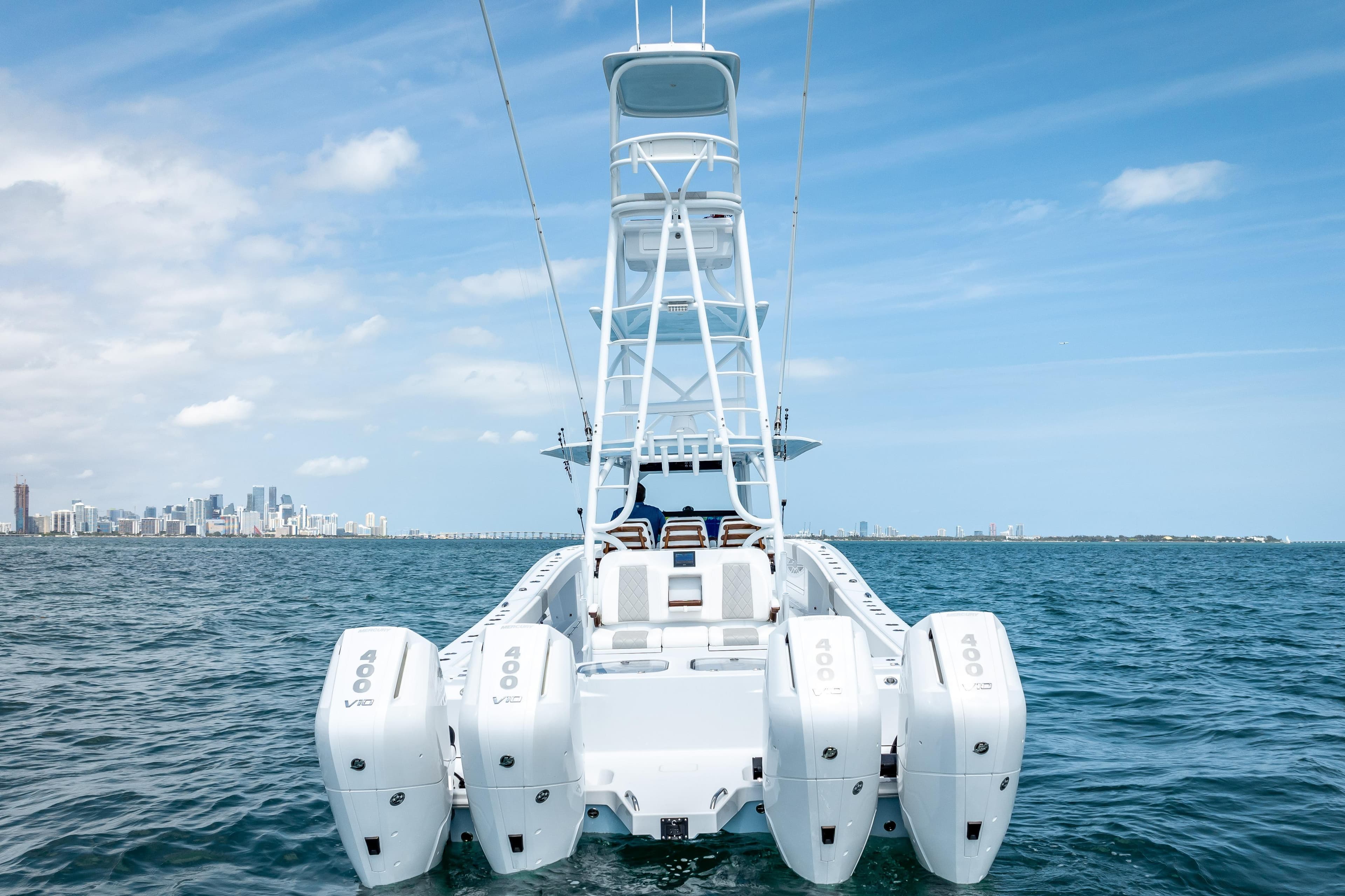 Freeman 43 boat with four engines on open water, city skyline in background, 2025 model.