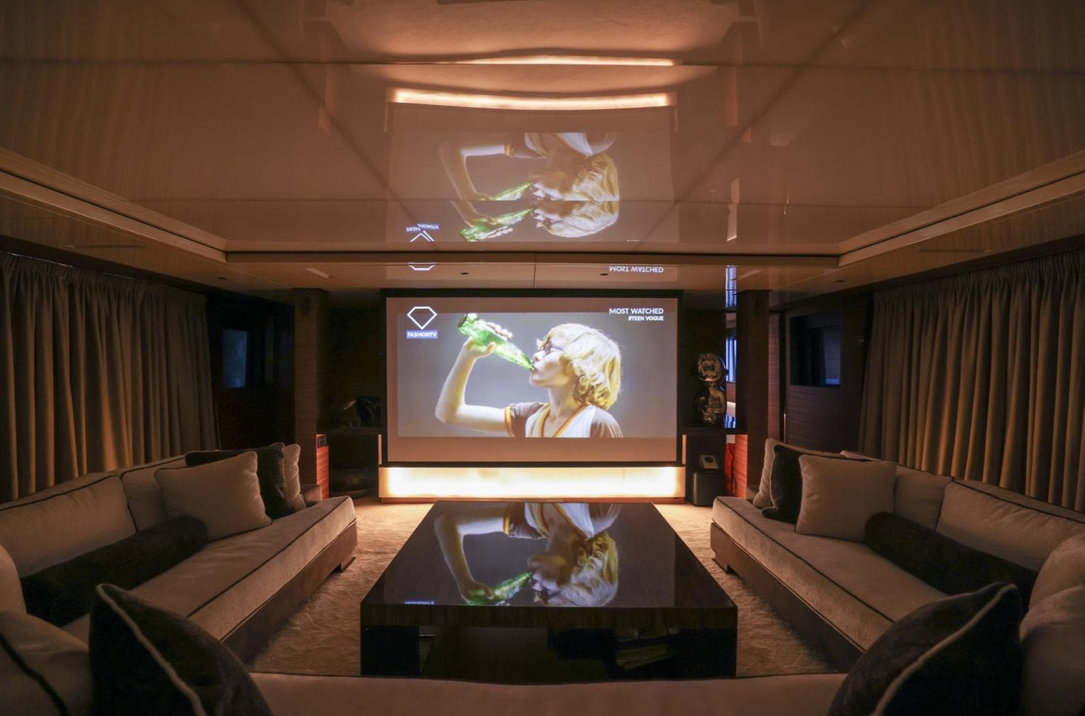 Luxurious yacht interior with home theater, plush seating, and modern decor, Elsflether Werft 1986.