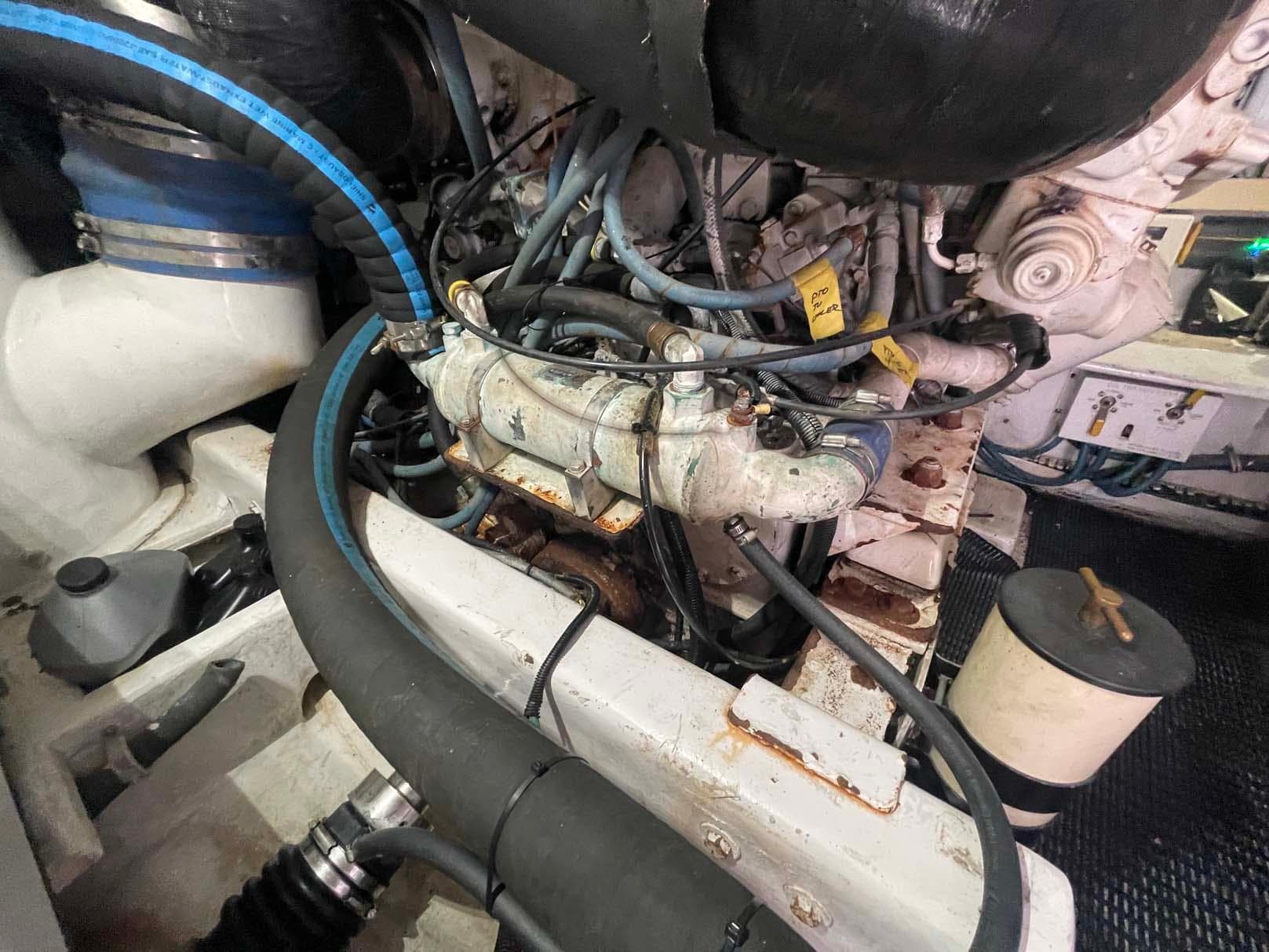 Engine compartment of a 1998 Viking 50 Convertible boat, showcasing hoses and mechanical components.
