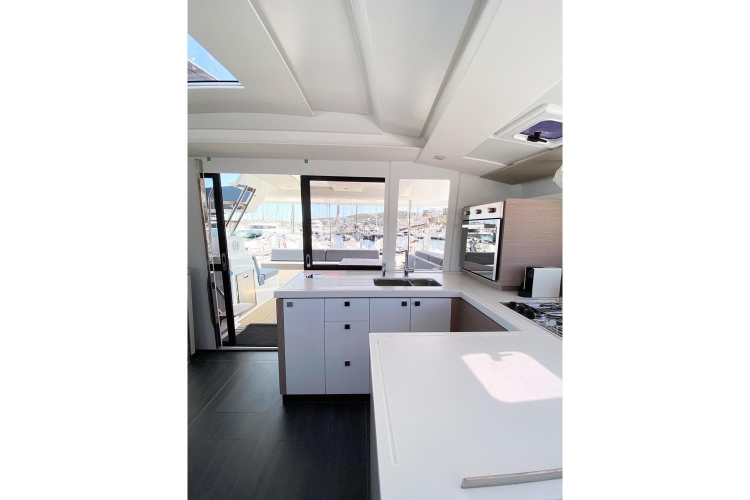 Modern kitchen interior of 2021 Fountaine Pajot Catamaran Astrea 42 with sleek design.