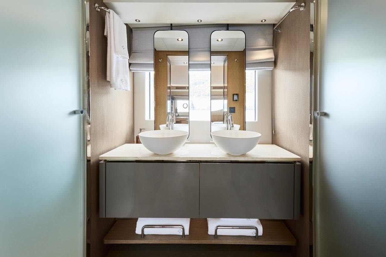 Modern bathroom interior in 2025 Prestige M7 yacht with dual sinks and sleek design.