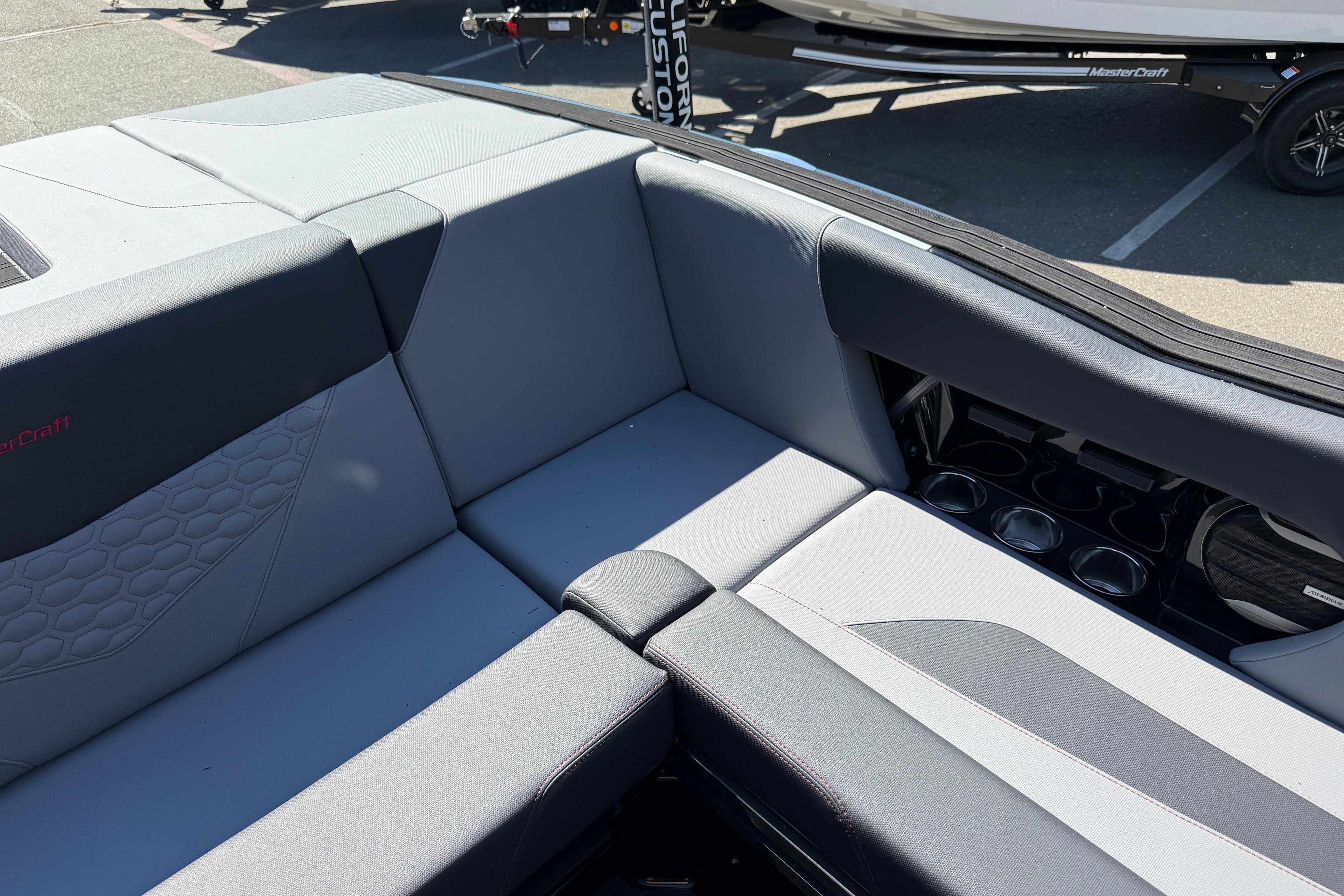 2026 MasterCraft NXT24 boat interior with gray seating and cup holders.