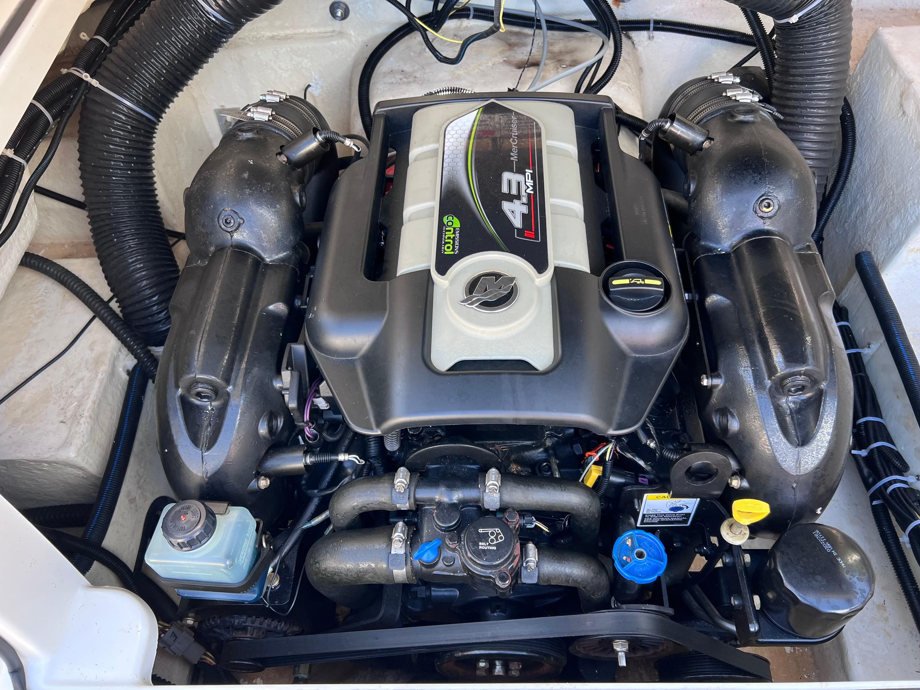 2016 Bayliner 195 Deck Boat engine compartment with 4.3L MerCruiser engine.