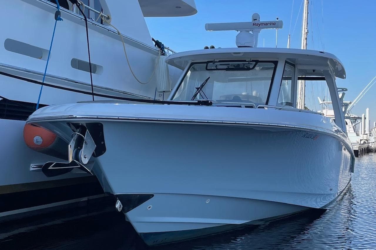2020 Boston Whaler 350 Realm boat docked in marina, showcasing sleek design.