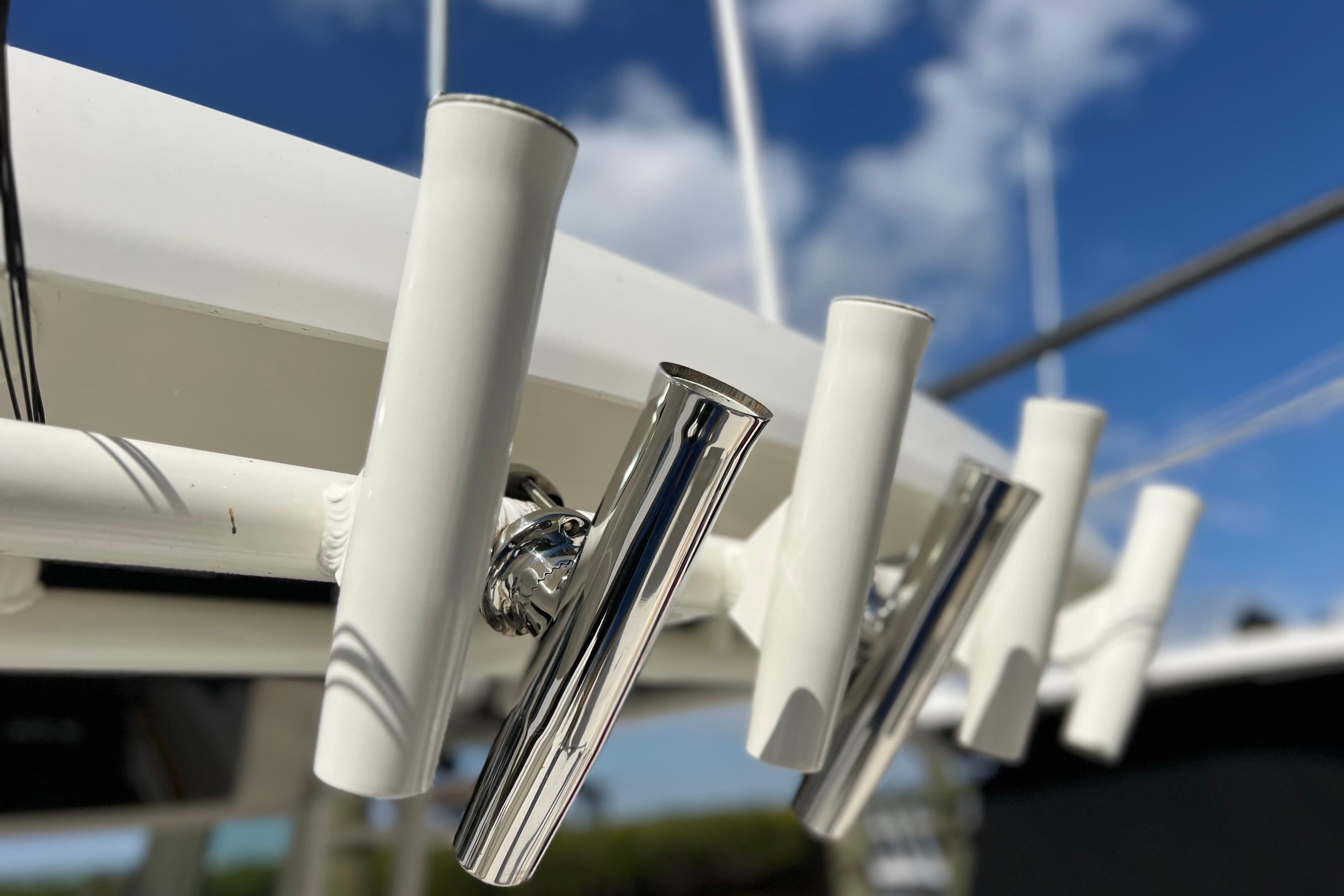 Rod holders on a 2021 Boston Whaler 330 Outrage against a blue sky.