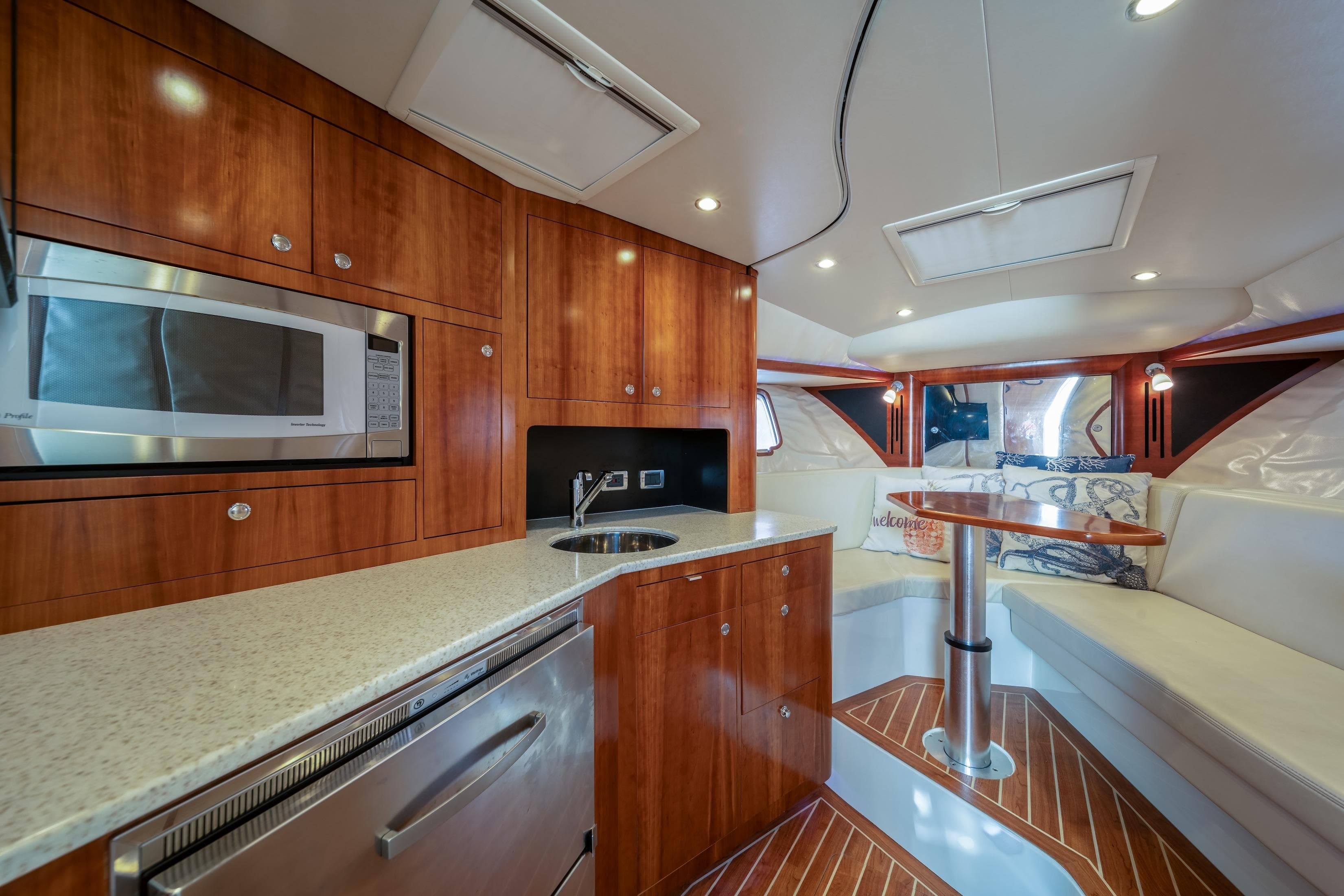 Luxurious interior of 2011 SeaVee 430 Sport Express with modern kitchen and cozy seating area.