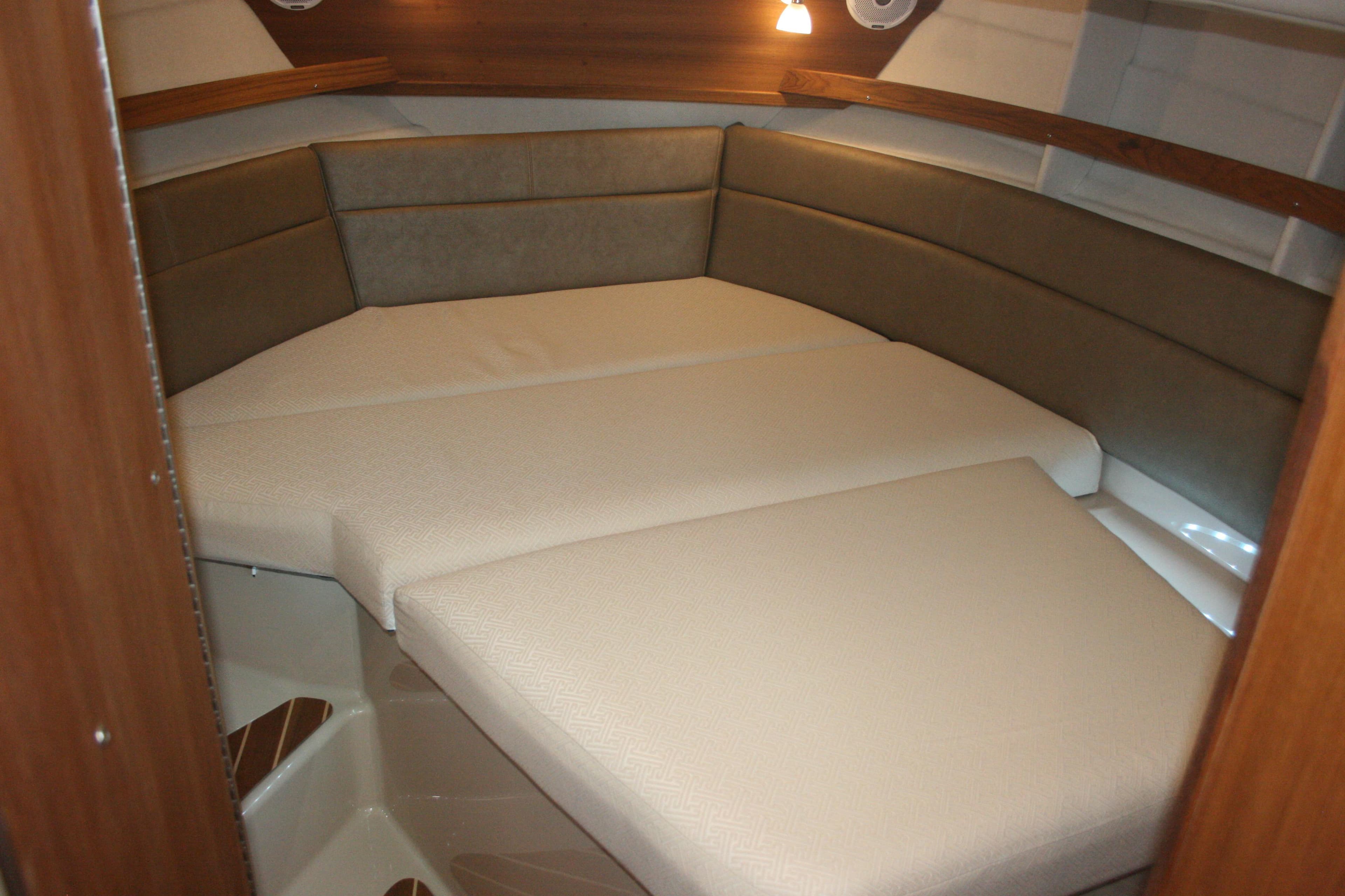 2019 Ranger Tugs R-31 CB interior cabin with cushioned seating and warm lighting.