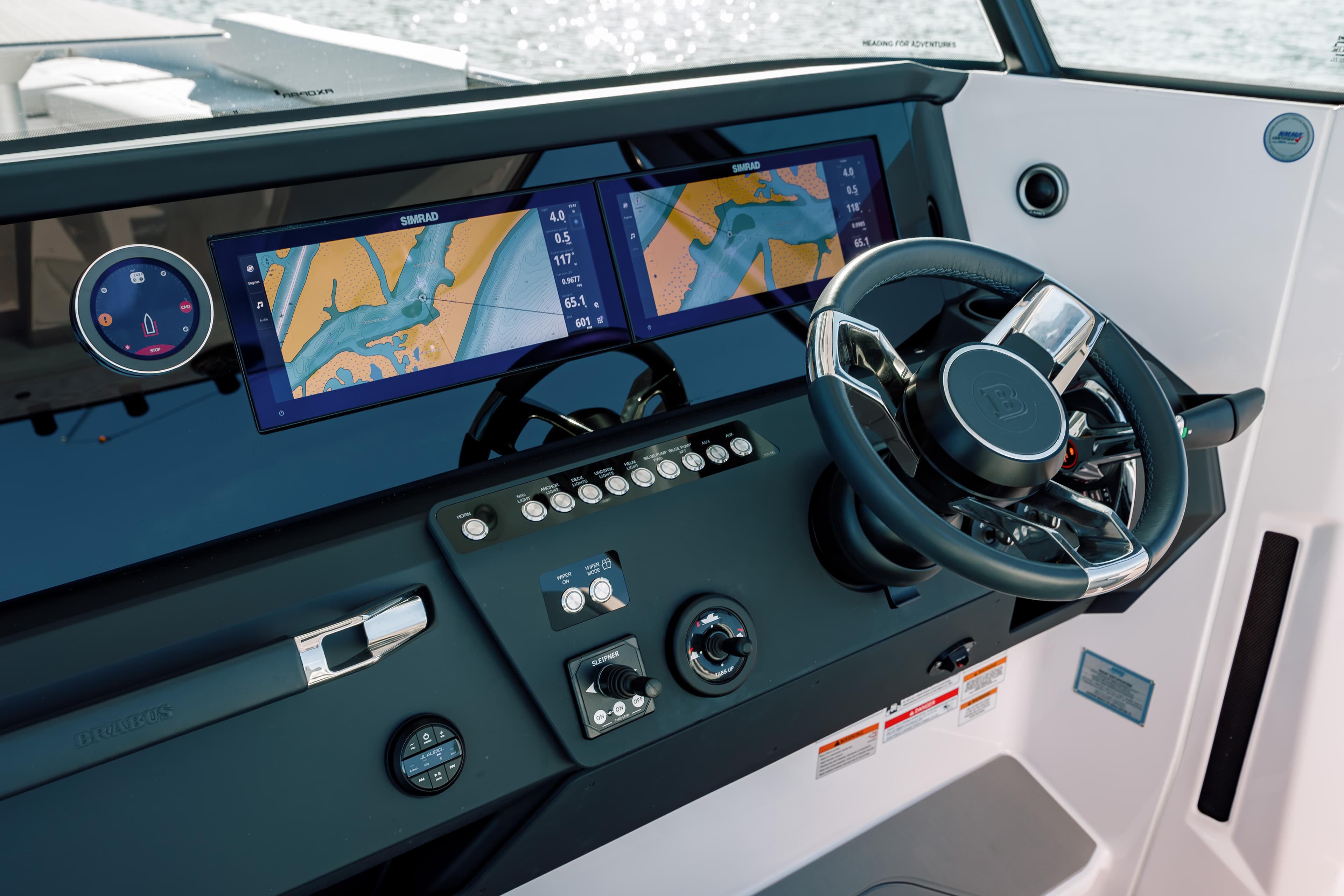 2025 Axopar 29 CCX boat dashboard with dual navigation screens and steering wheel.
