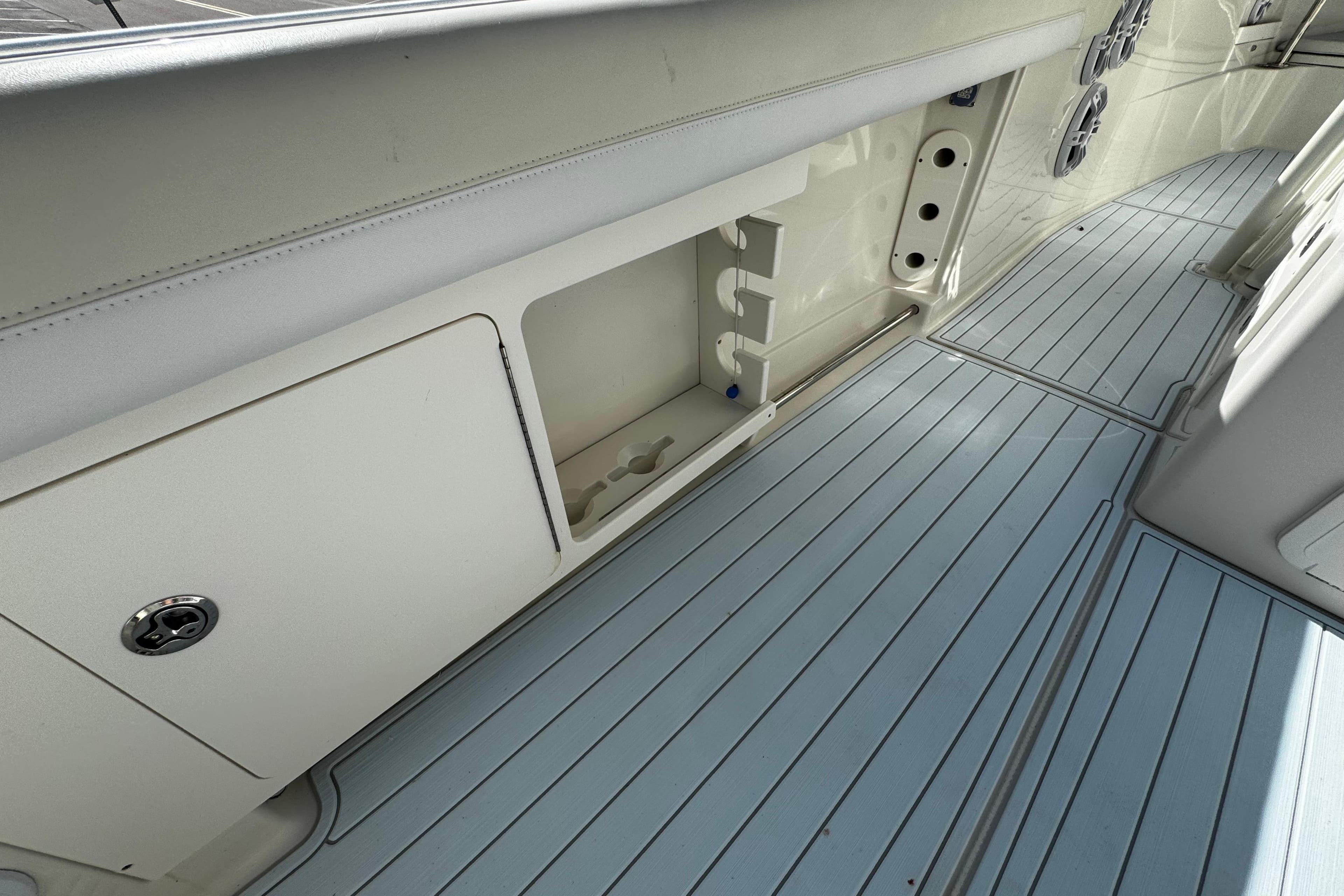 2015 Sailfish 320 CC boat interior with storage compartment and sleek flooring.