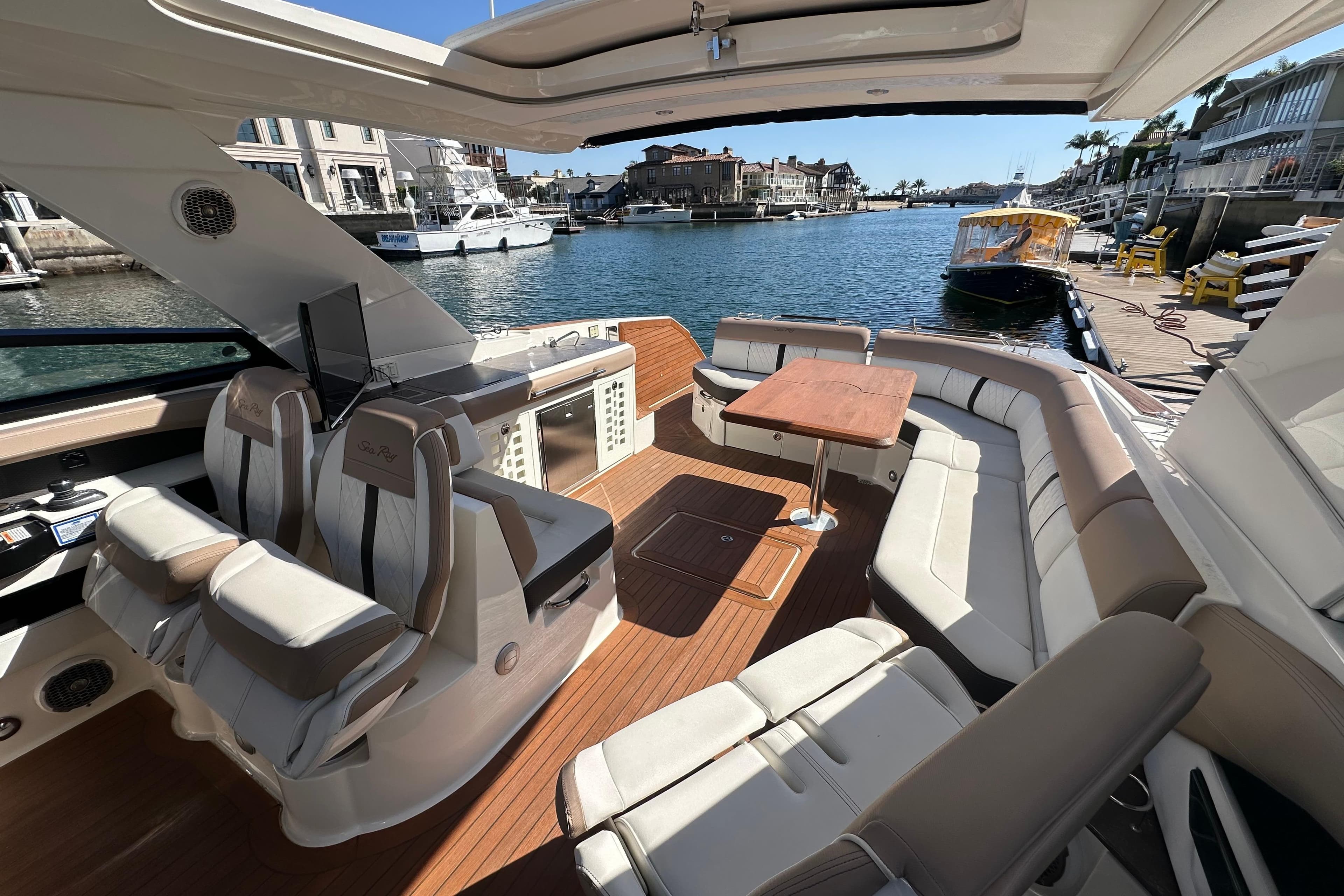 Luxurious 2018 Sea Ray SLX 400 boat interior with plush seating and waterfront view.