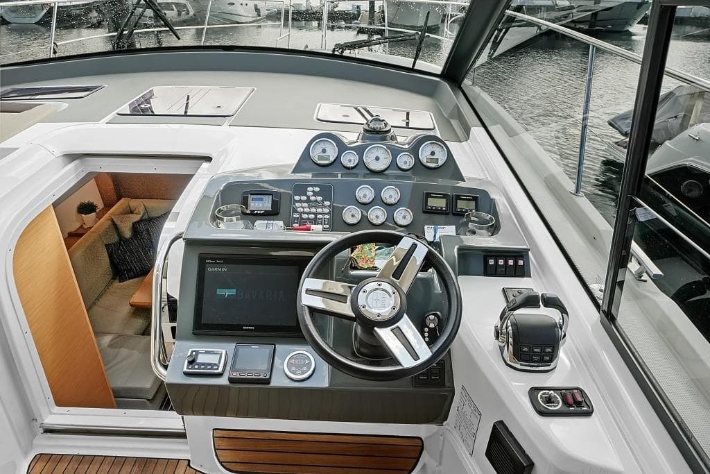 Cockpit of 2017 Bavaria S40 Coupe yacht with modern navigation instruments and cozy interior.