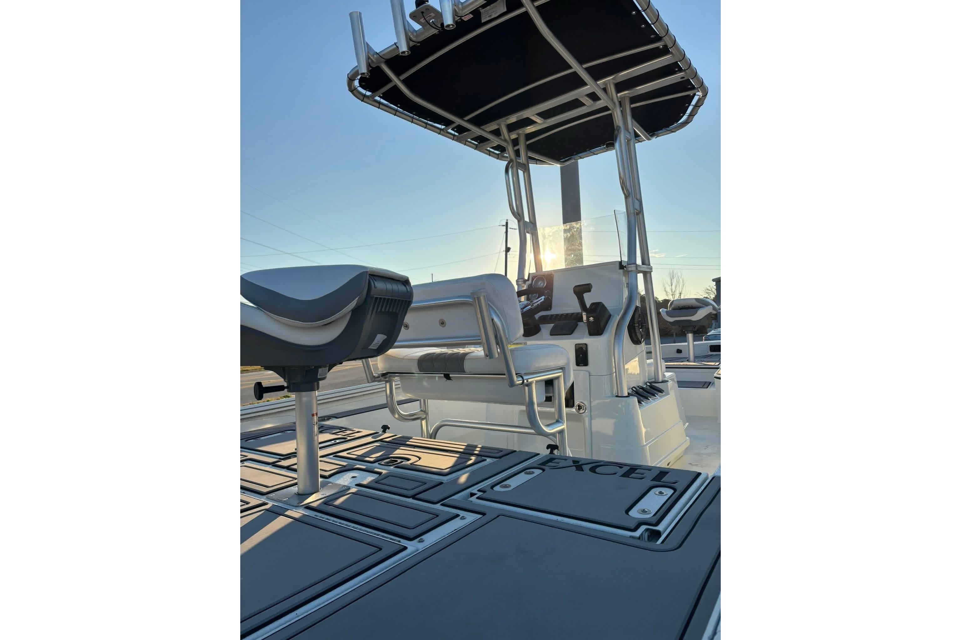 2026 Excel 220 Bay Pro Elite boat interior with seating and console, under a clear sky.
