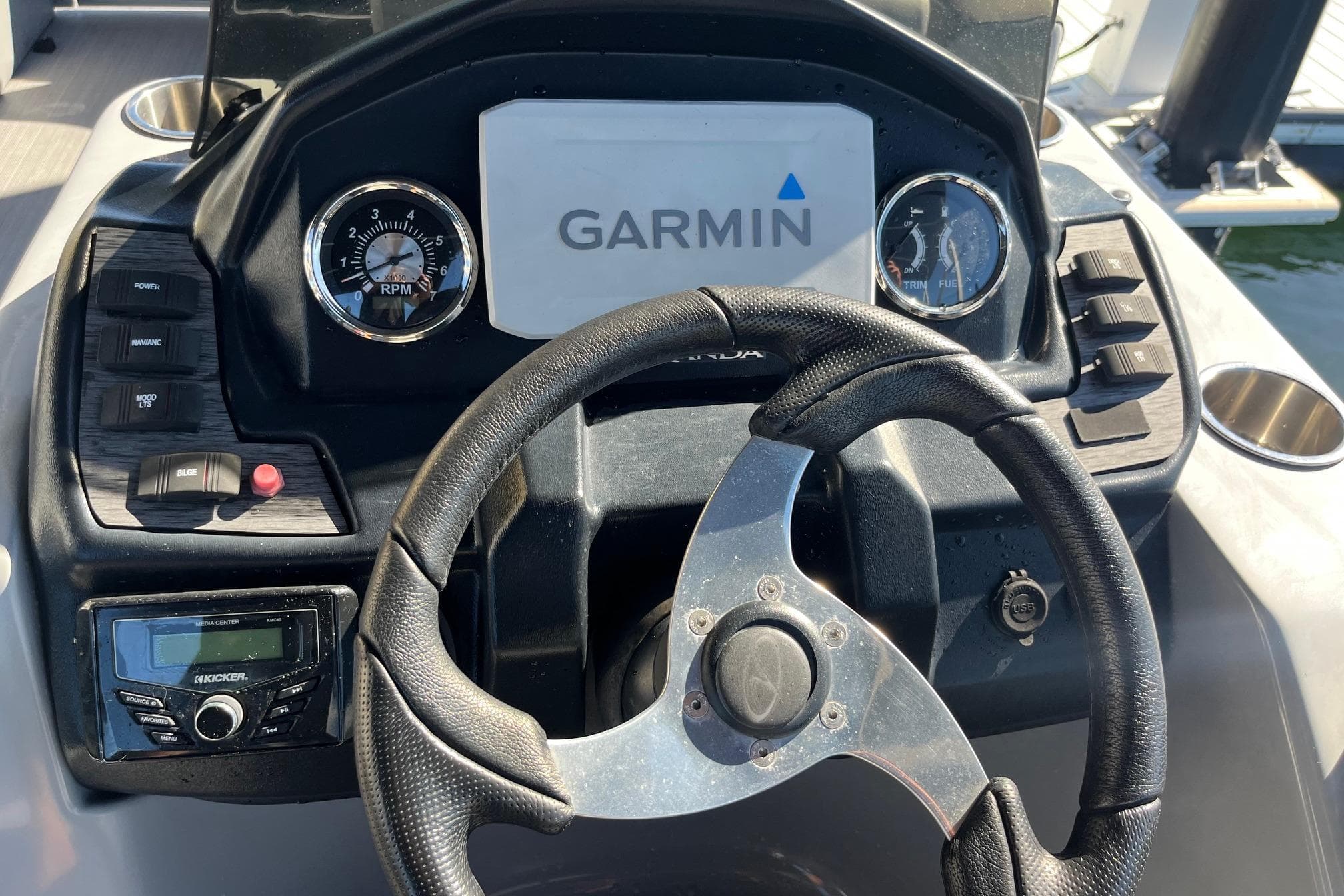 2023 Veranda Relax VR22RC boat dashboard with Garmin display and steering wheel.