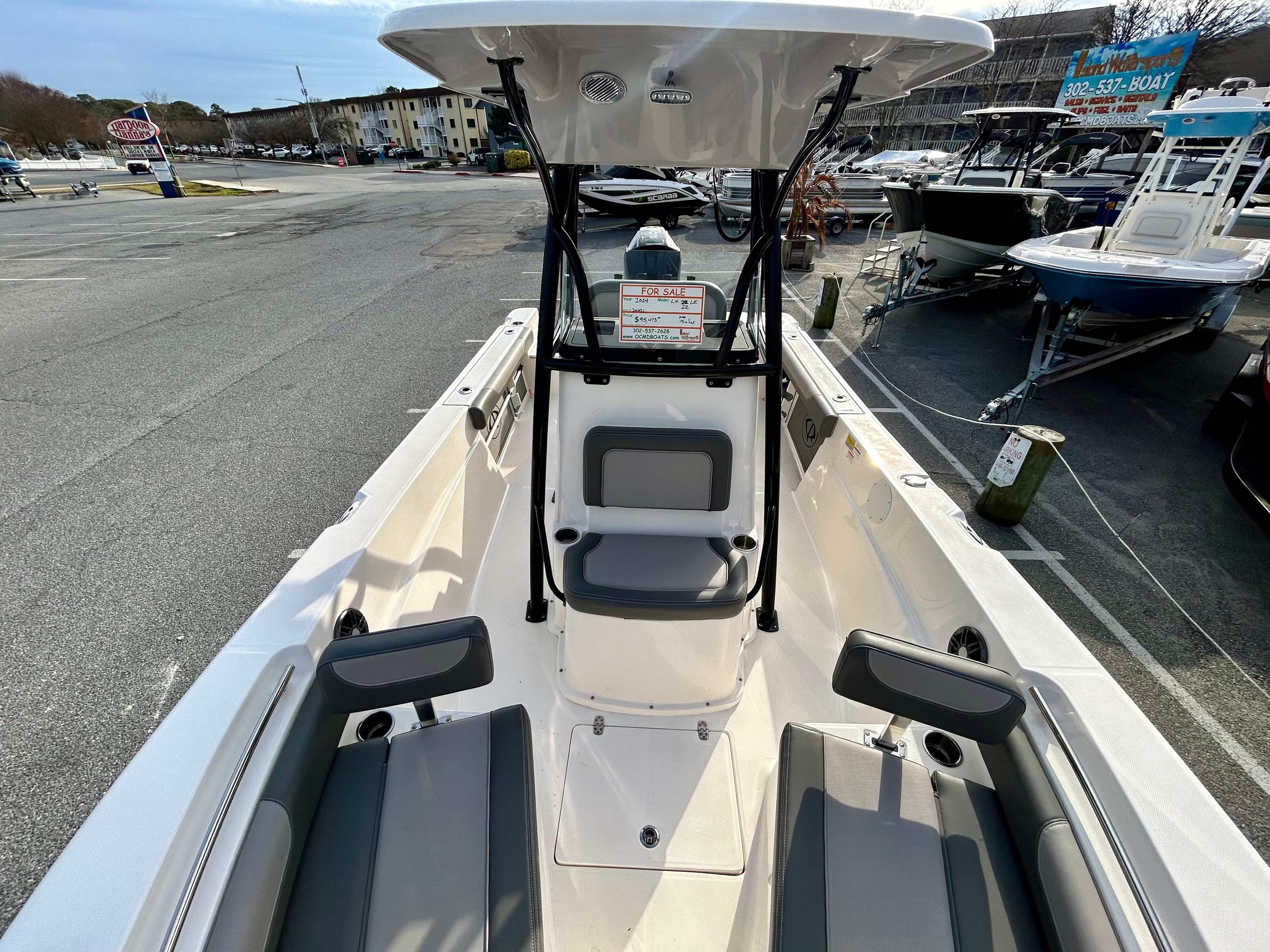 2024 Sea Born LX 22 LE boat interior, featuring seating and console, docked at a marina.