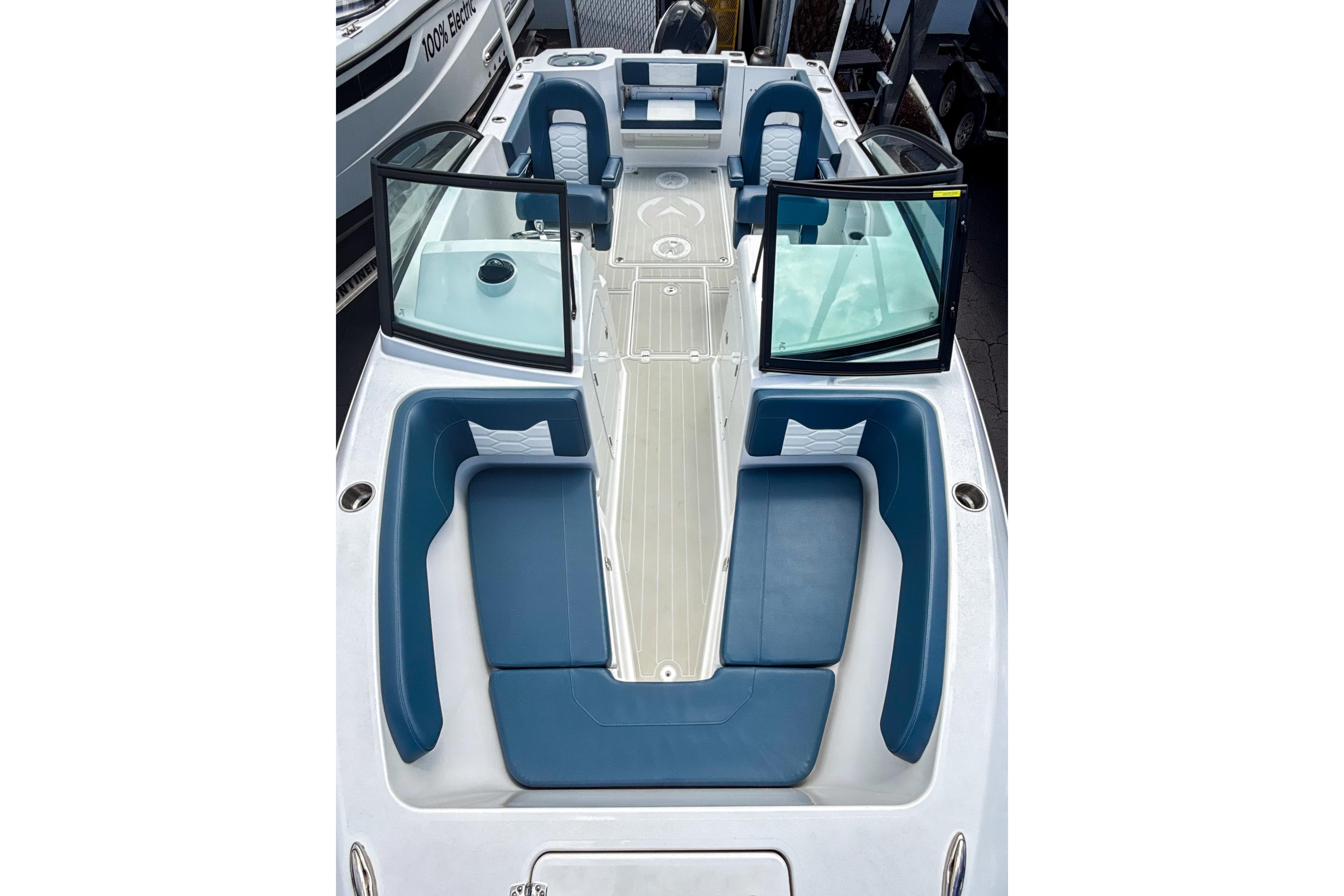 2024 Aquasport AS DC 22 boat interior with blue seating and open windshield.