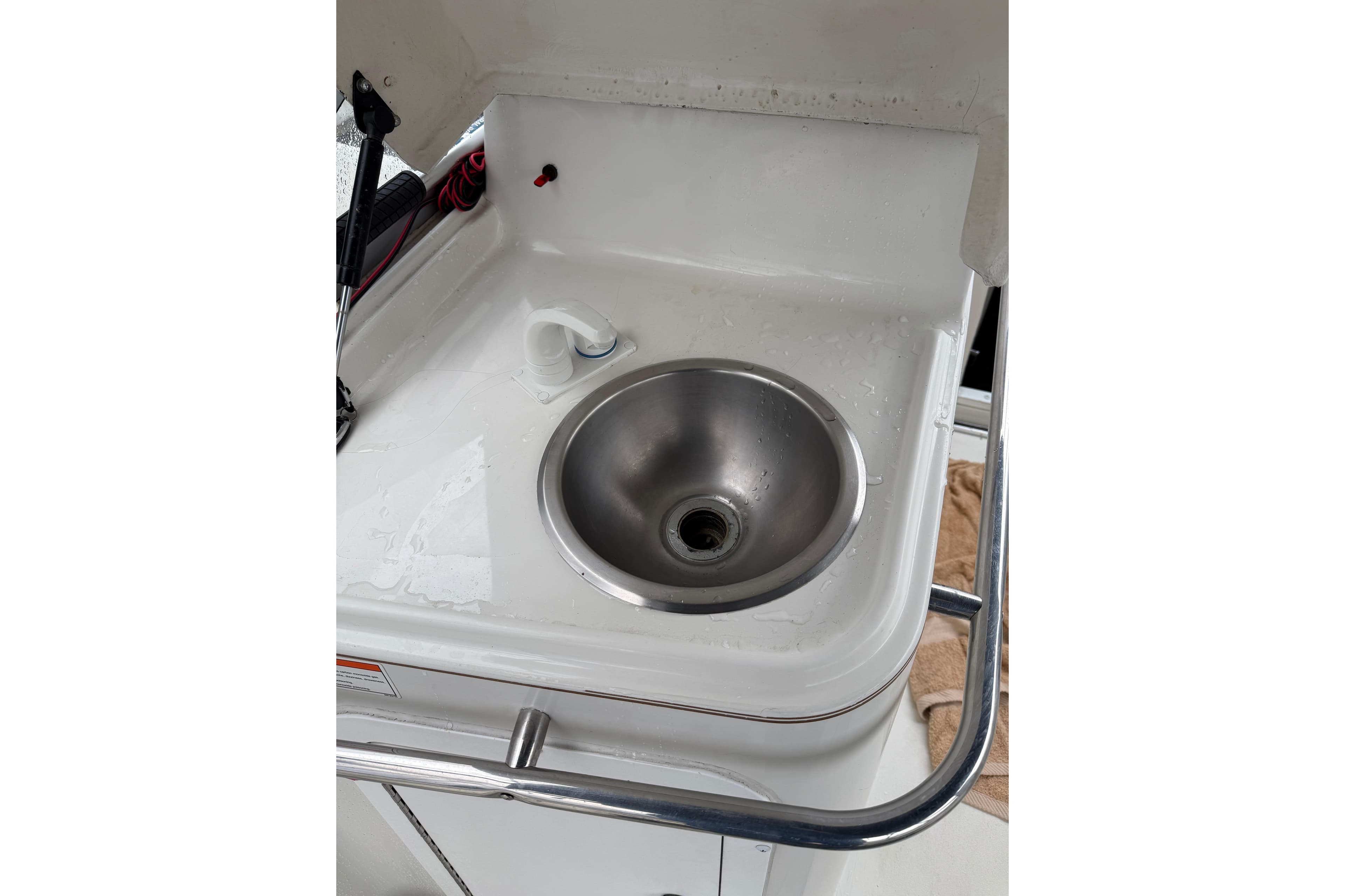 Stainless steel sink on 1997 Larson Cabrio 310 Mid-Cabin boat.