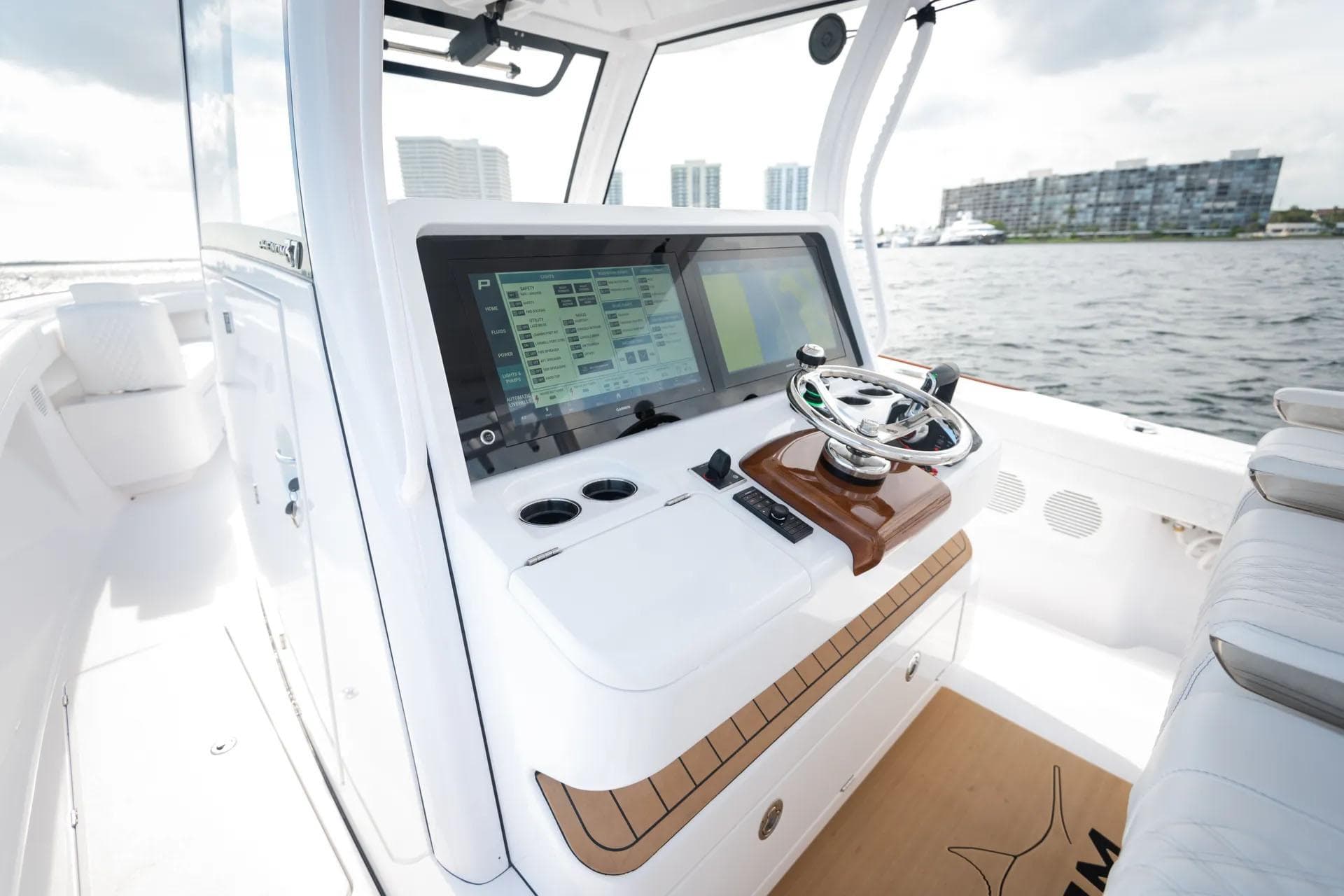 Manufacturer Provided Image: Phenom 37 boat dashboard with advanced navigation system, 2025 model, on a sunny day.