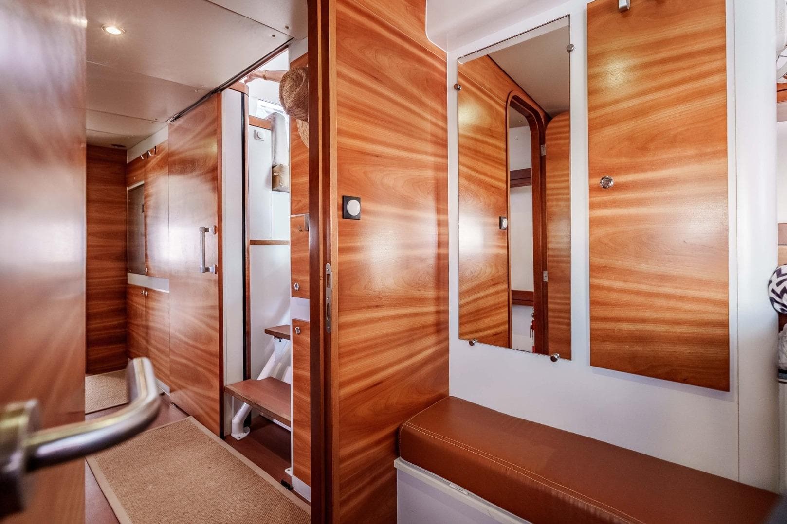 Interior of 2012 Outremer 49 yacht with wooden finishes and mirrors.