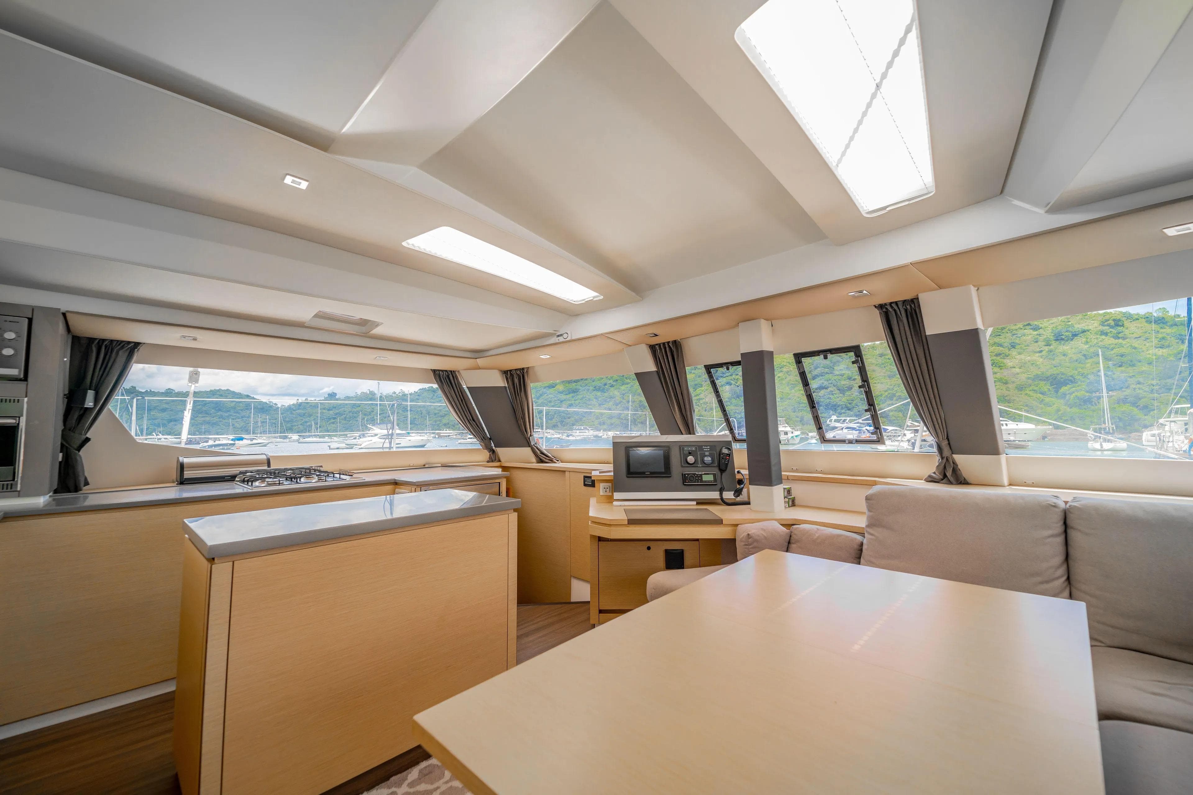Luxurious interior of 2016 Fountaine Pajot SABA 50 catamaran with modern kitchen and seating area.
