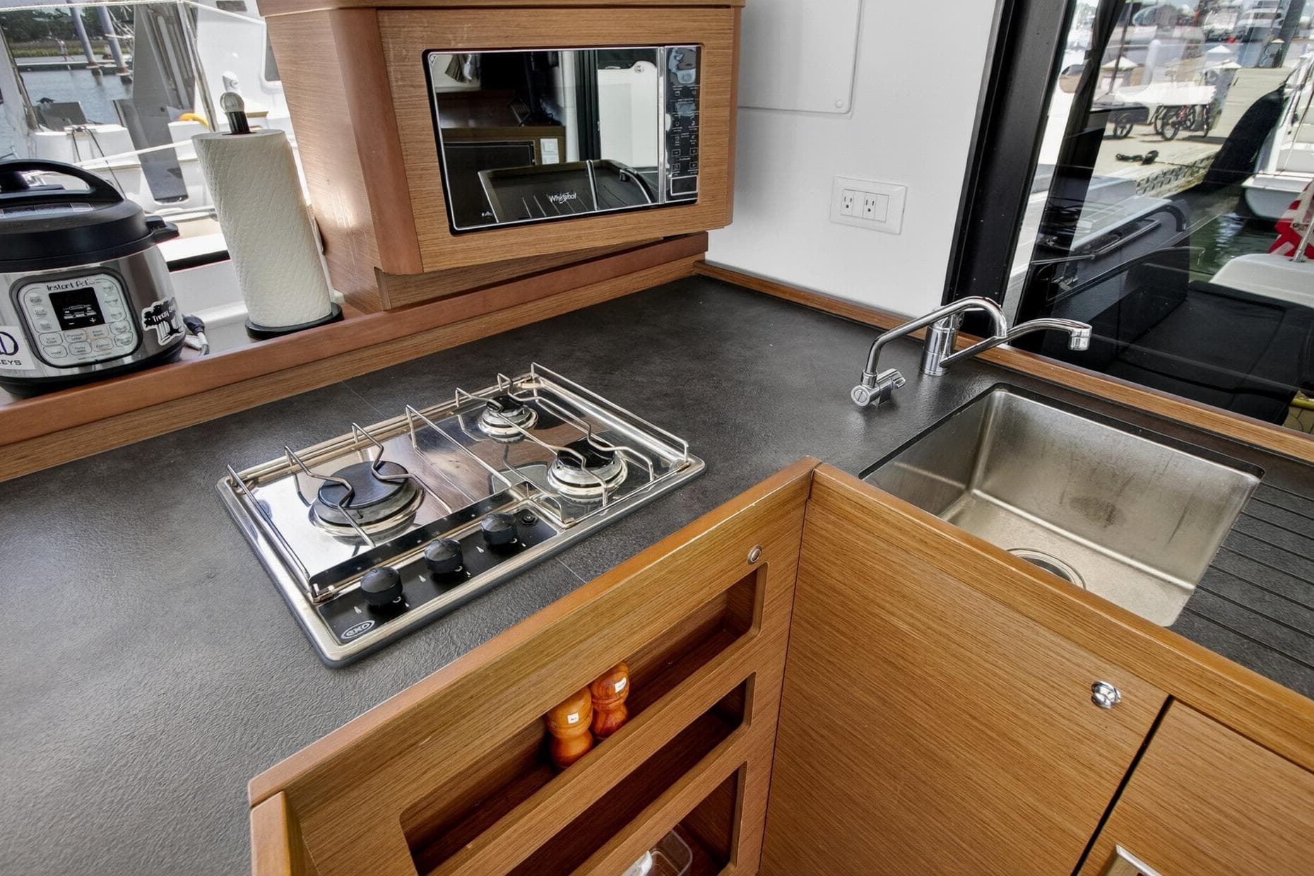 Modern kitchen in 2018 Lagoon 42 yacht with stove, sink, and appliances.