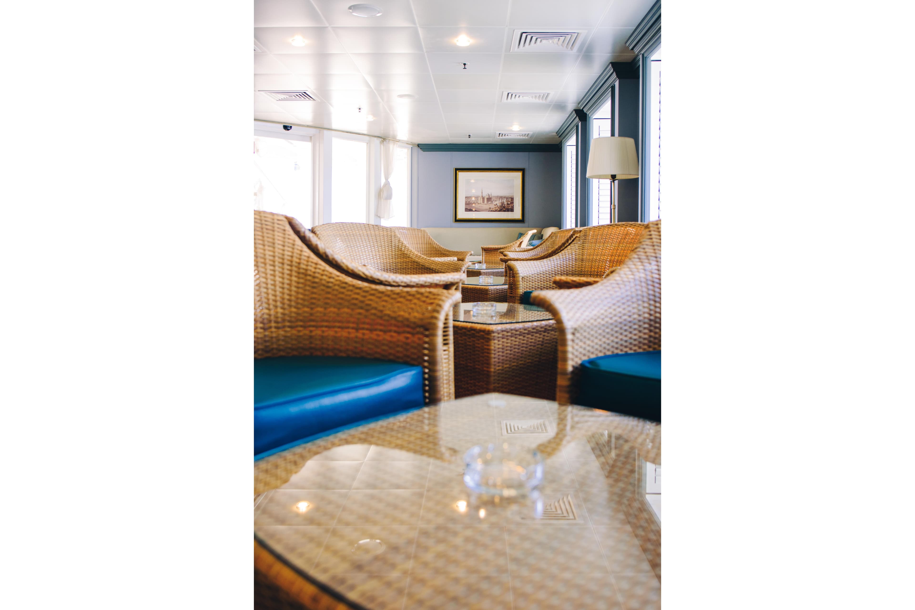 Luxurious lounge area with wicker chairs on 1996 Custom cruise ship MINERVA.