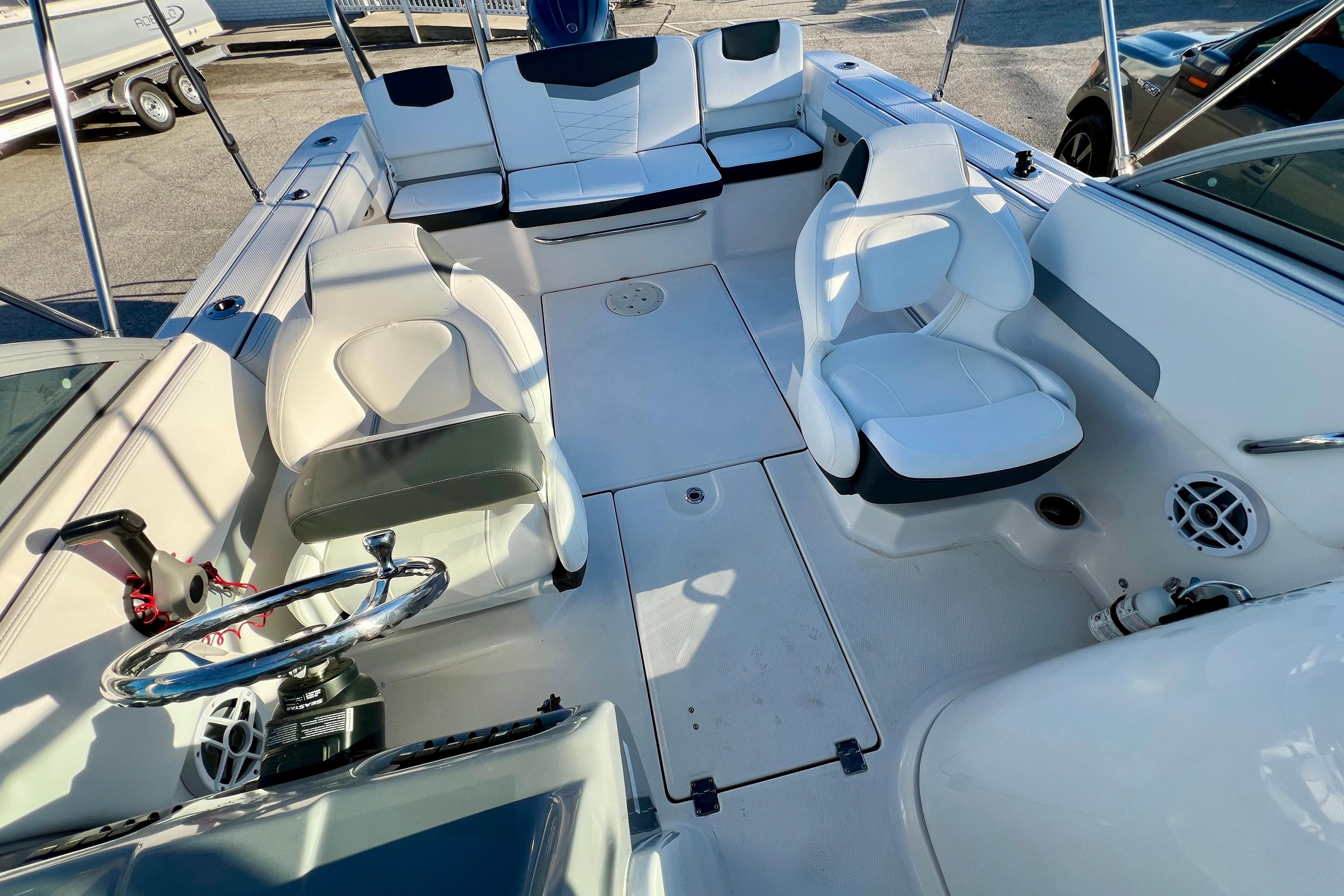 2024 Robalo R207 Dual Console boat interior with seating and steering wheel.
