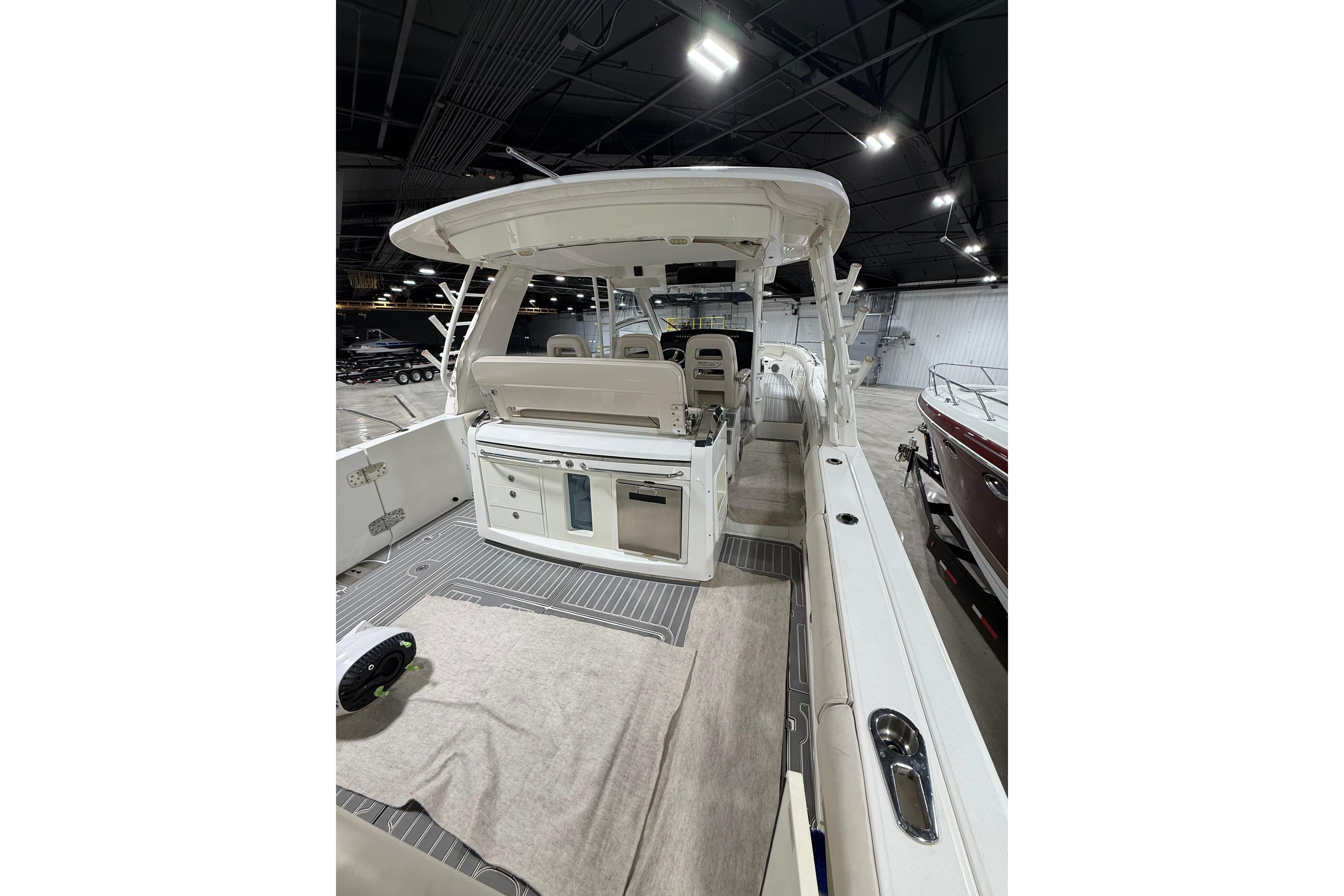2016 Boston Whaler 420 Outrage boat interior with seating and storage, displayed indoors.