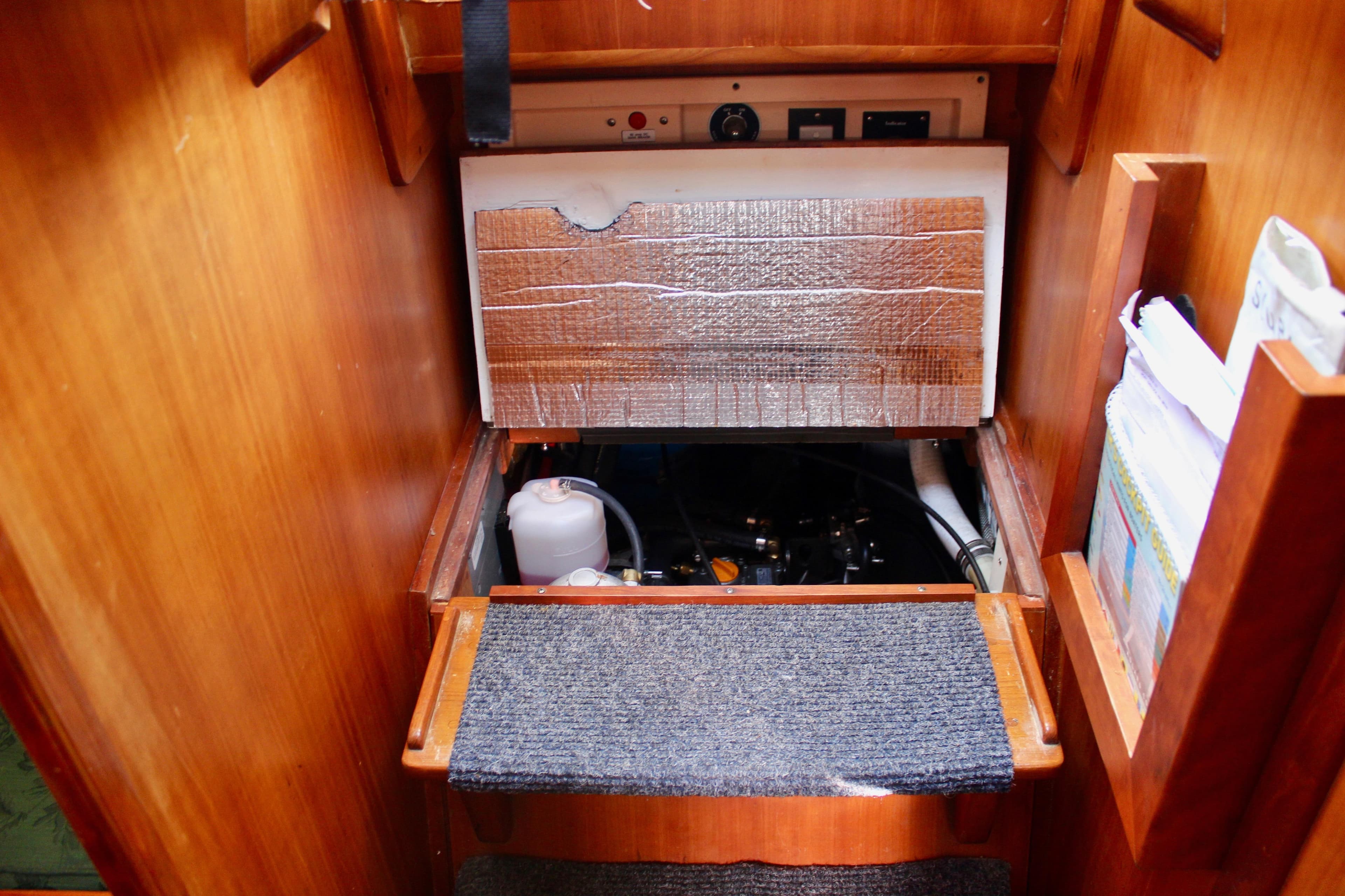 1997 Valiant 39 yacht engine compartment with insulation and storage shelves.