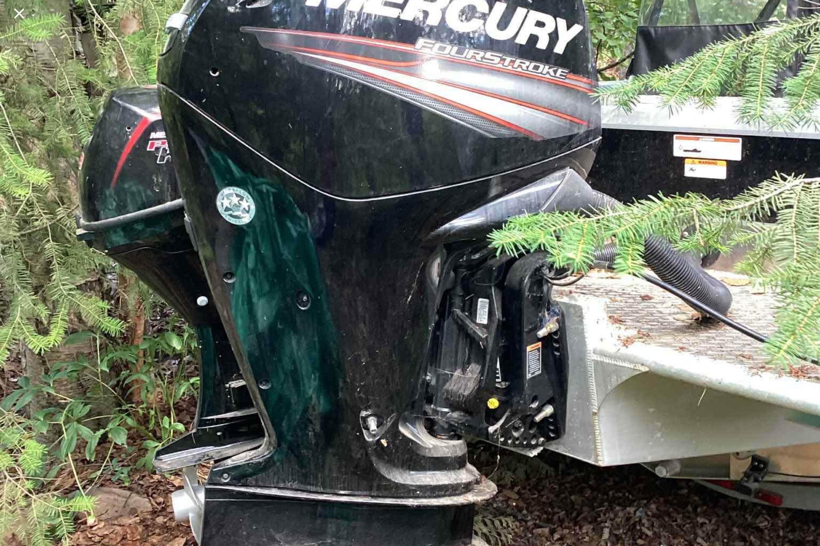 2018 Thunder Jet 185 Explorer with Mercury FourStroke outboard motor in a wooded setting.