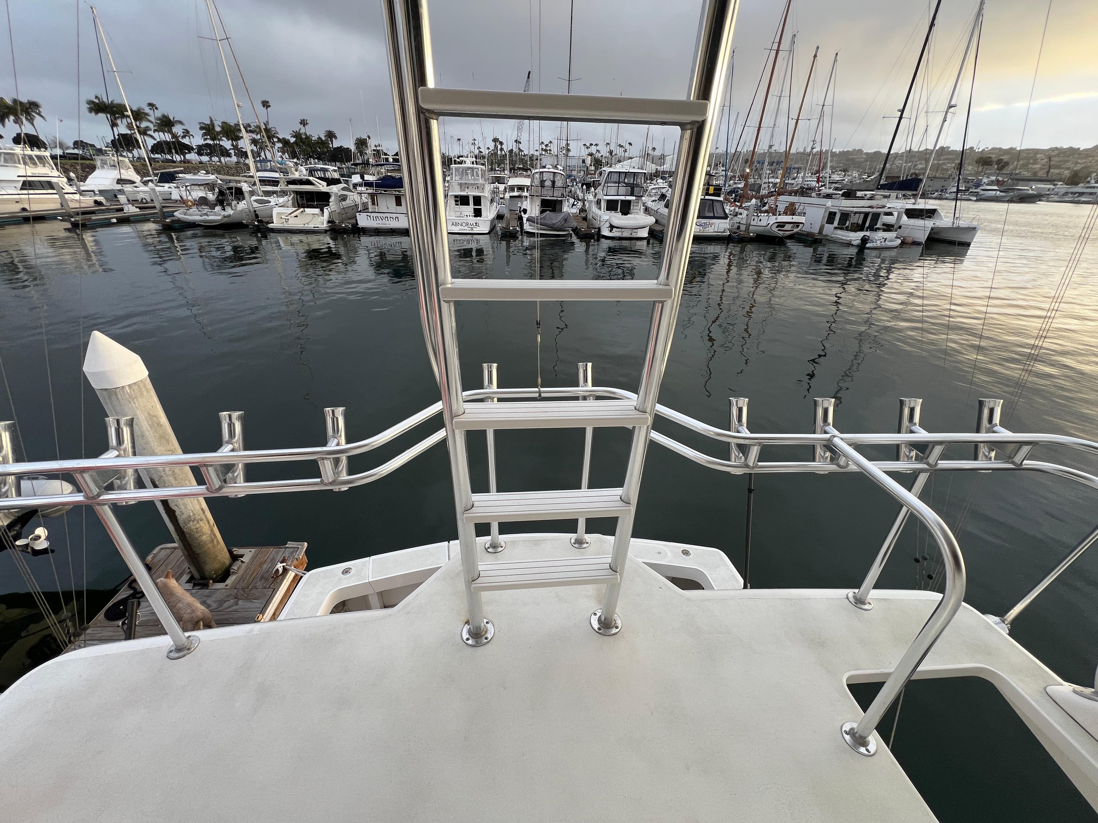 View from Viking 58 Enclosed Bridge yacht, overlooking marina with numerous docked boats.