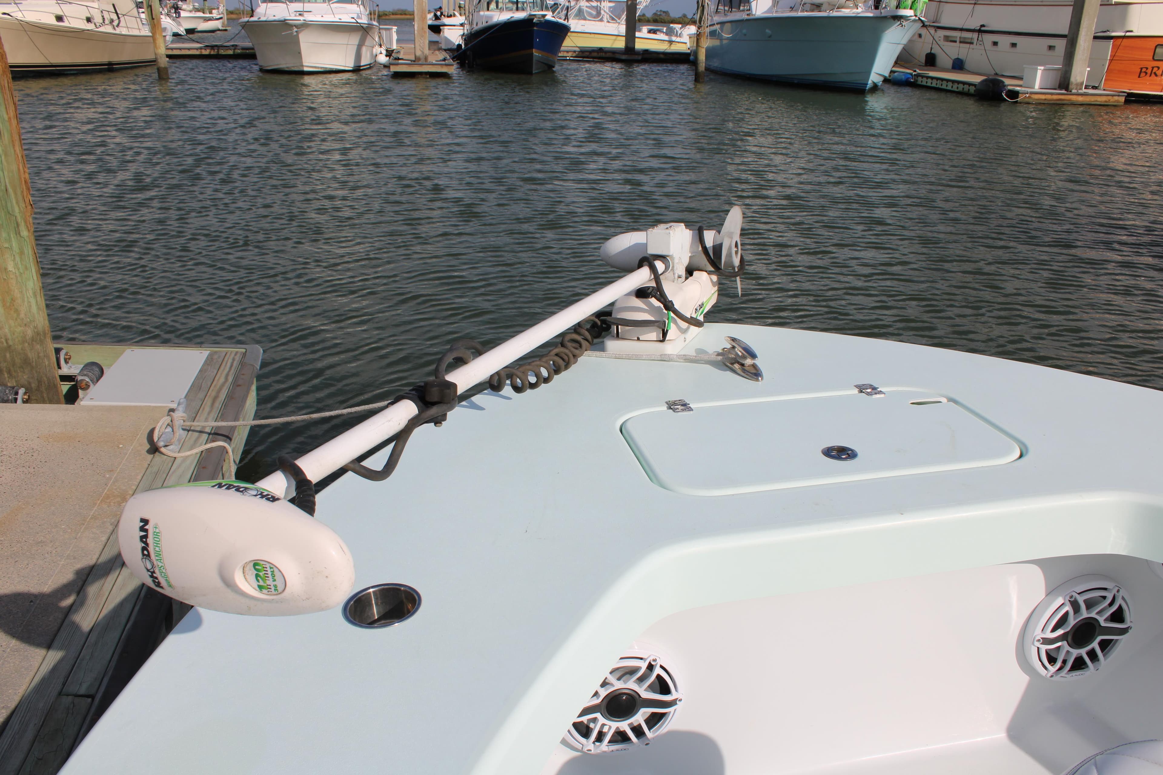 ZCB 26 Freemason 2021 boat with trolling motor docked in marina.