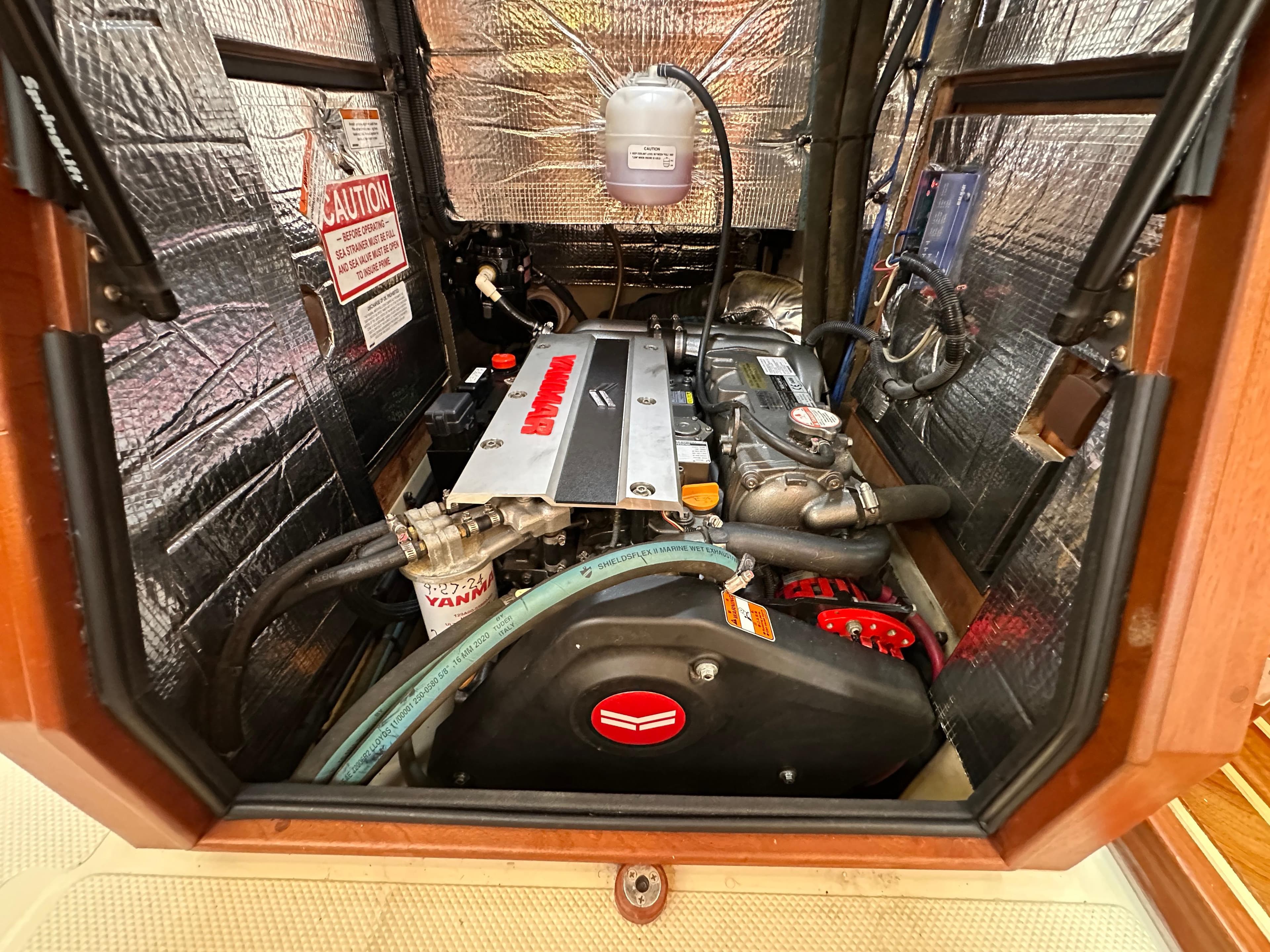 Engine compartment of a 2021 Island Packet 439 sailboat, featuring a Yanmar engine.