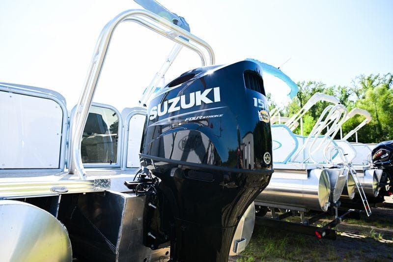 2023 Aloha Pontoon Mahalo 23 with Suzuki outboard motor, parked outdoors.