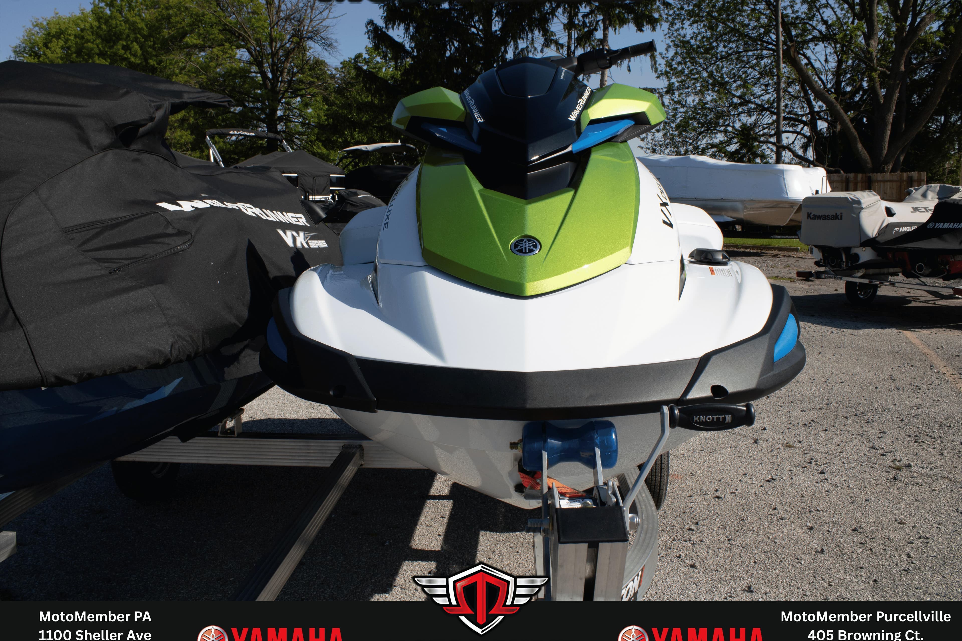 2026 Yamaha WaveRunner VX Deluxe in vibrant green and white, parked outdoors.