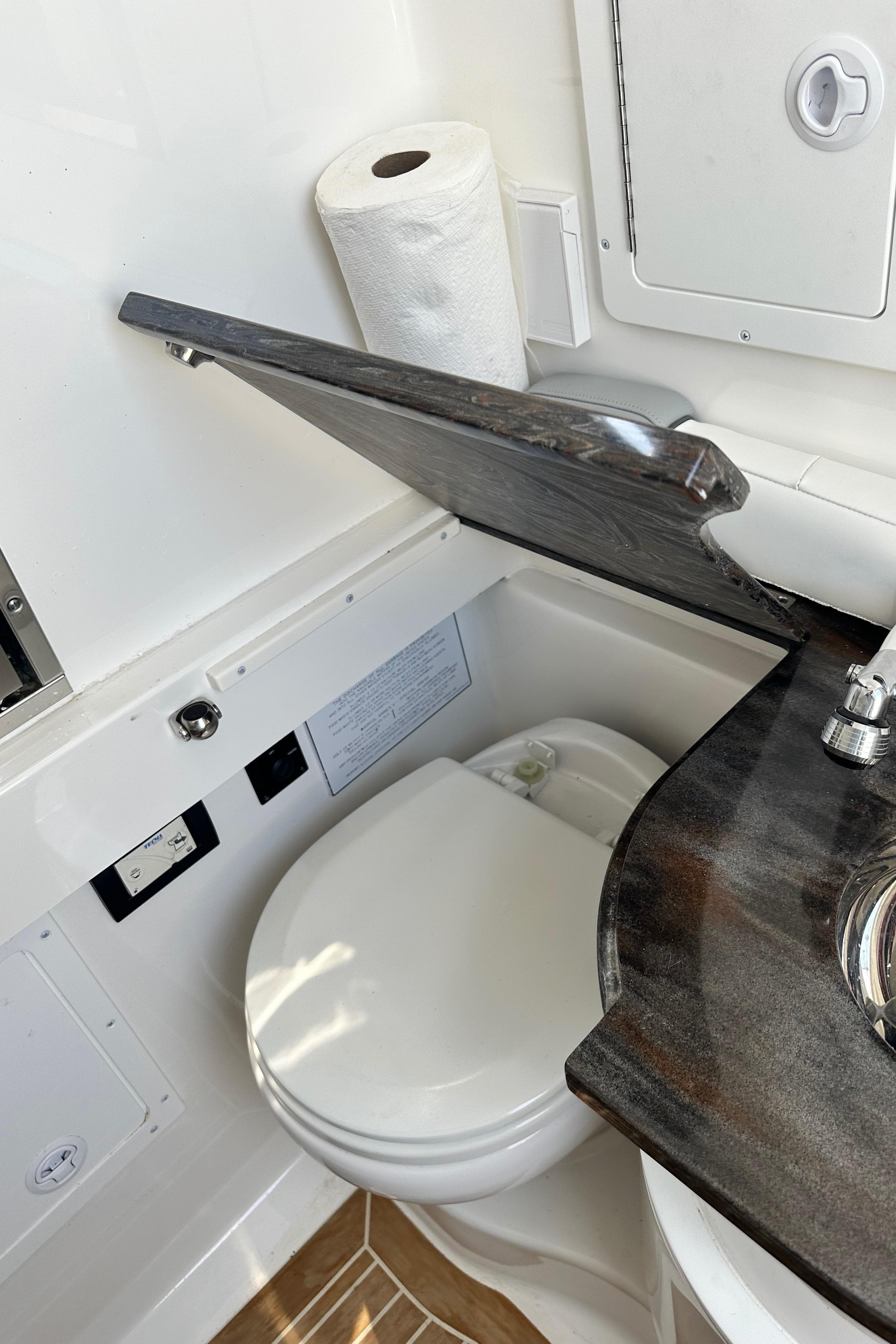 2022 Regulator 34 boat bathroom with toilet, sink, and storage.