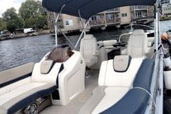 2022 Avalon Catalina Quad Lounge 24' pontoon boat with spacious seating on a serene lake.