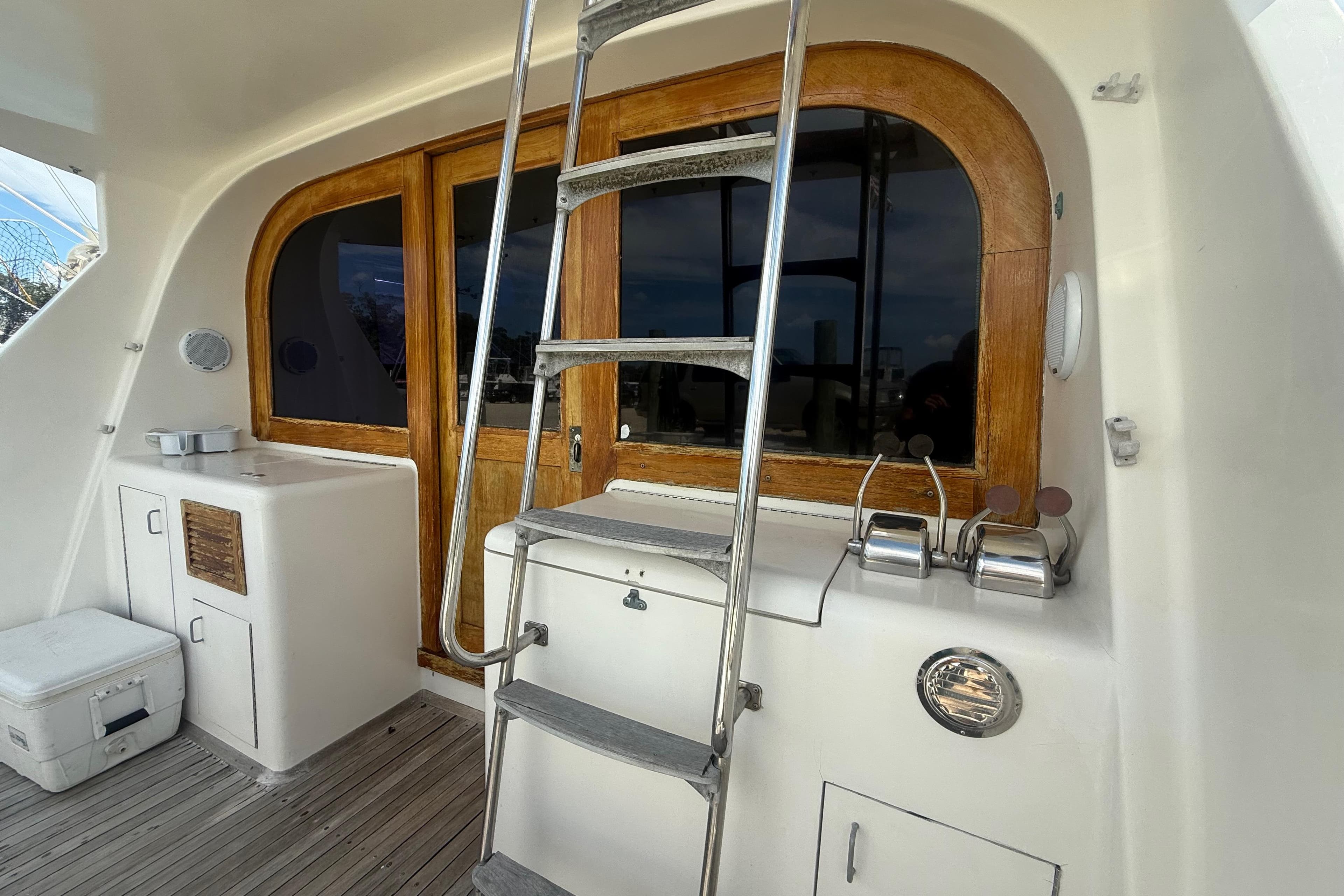 1986 Ocean Yachts 38 Super Sport boat interior with ladder and wooden accents.