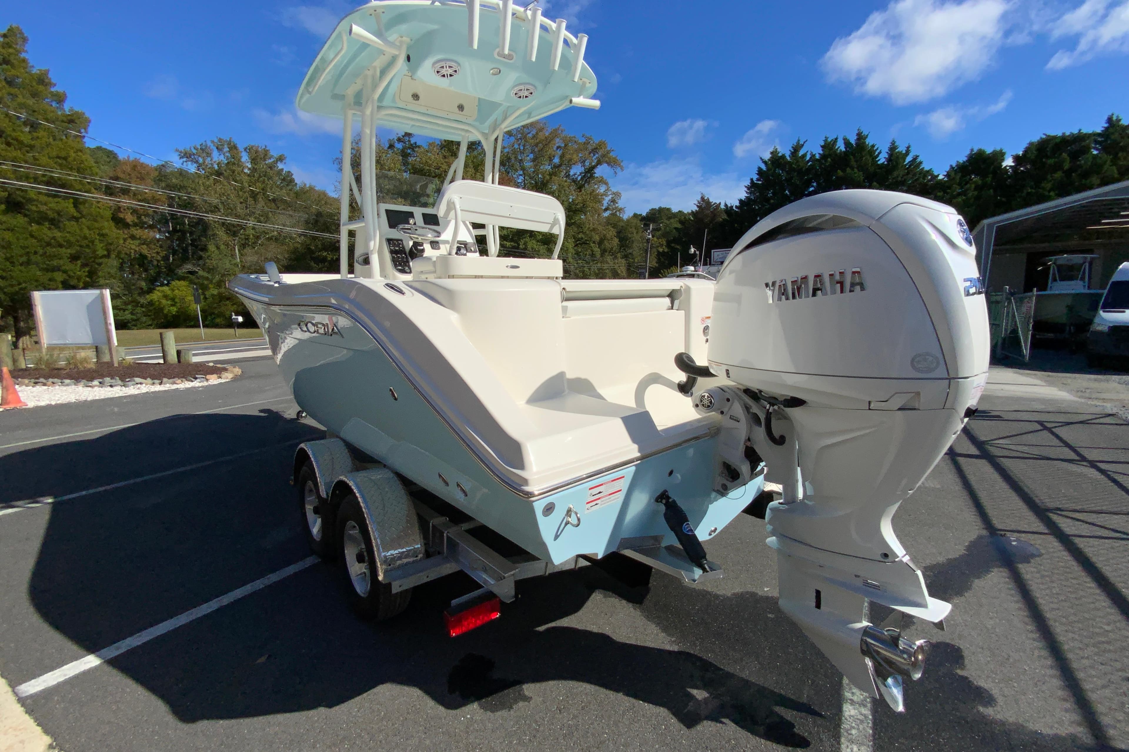 2026 Cobia 220 Center Console boat with Yamaha engine on trailer.