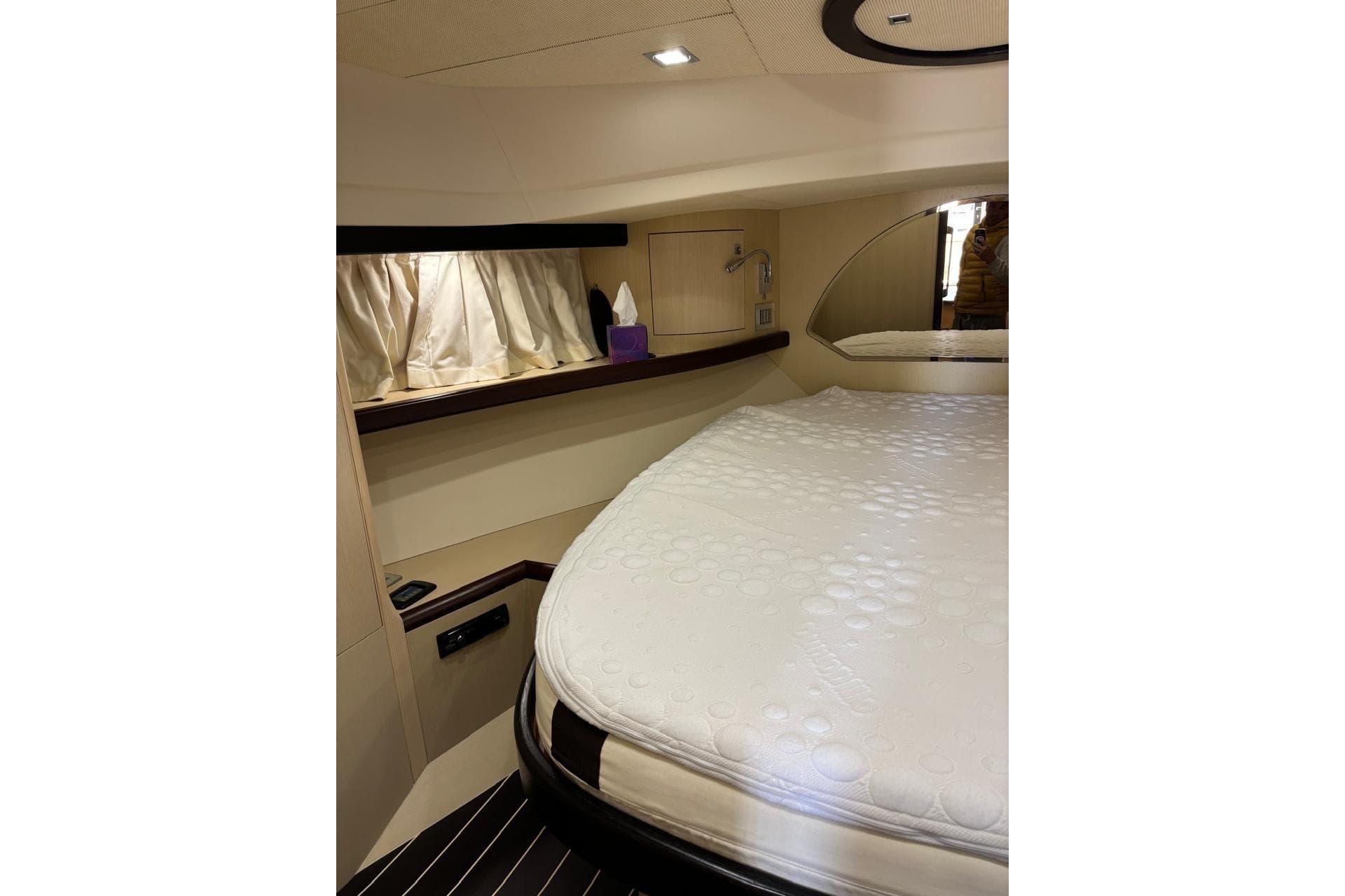 Luxurious cabin interior of 2010 Portofino 47 Fly yacht with elegant bedding.