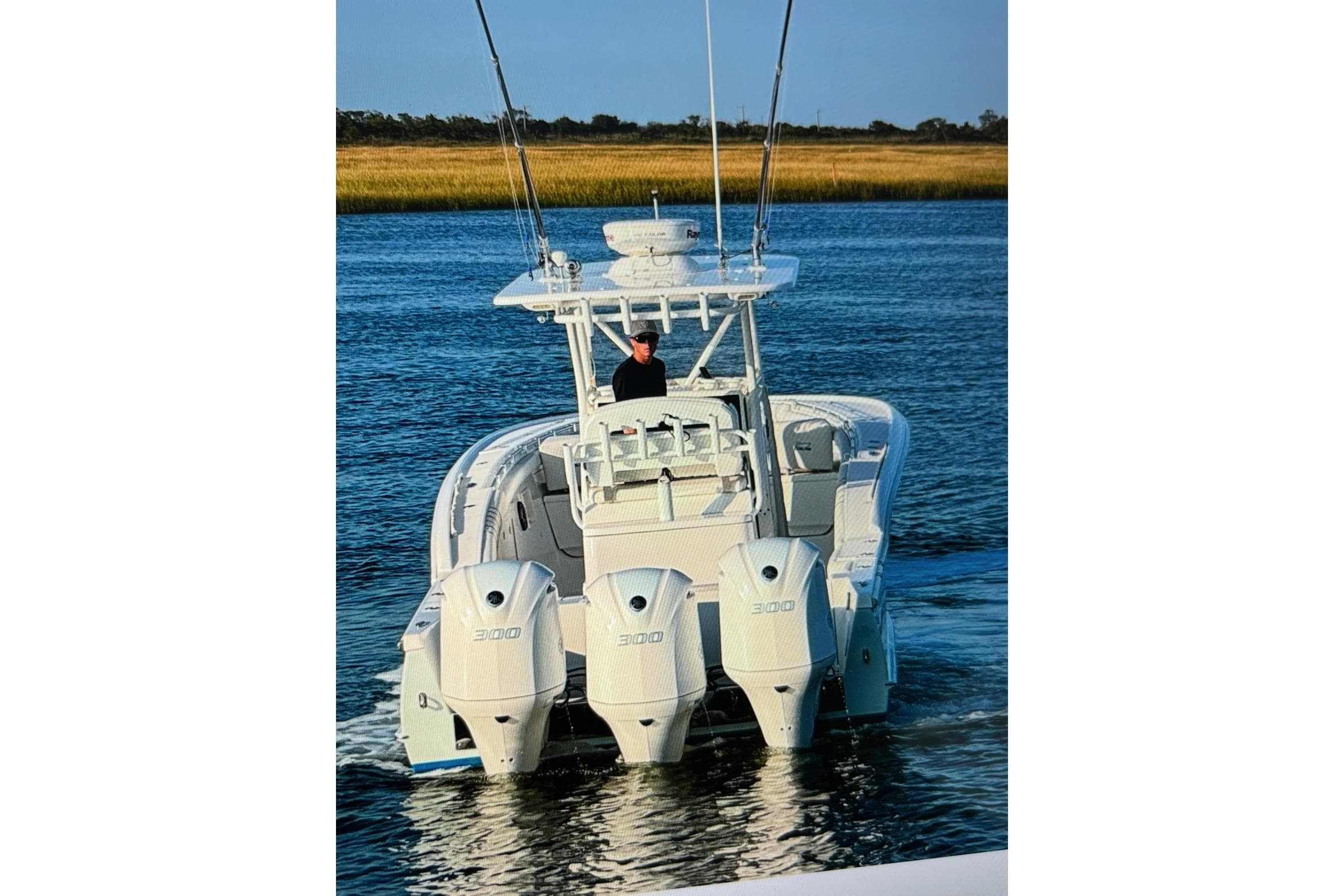 2017 Buddy Davis 34 Center Console boat with triple 300 engines on water.