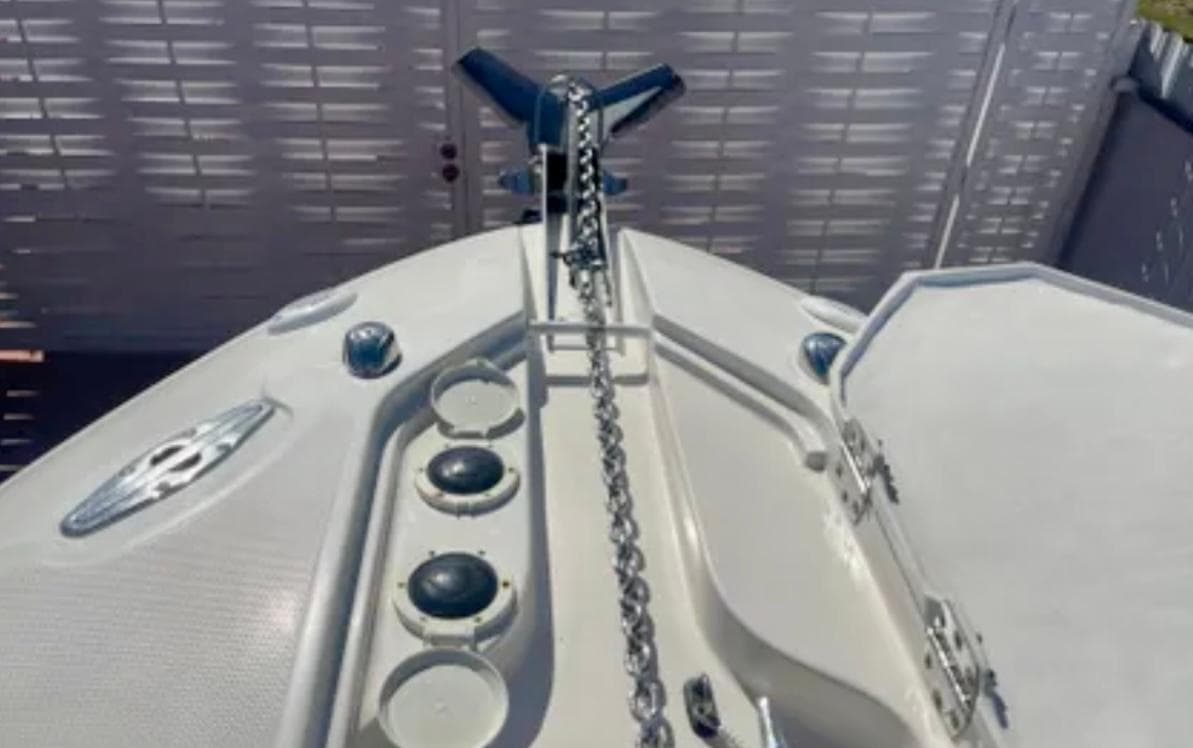 Bow of 2006 Wellcraft 32 CCF boat with anchor chain and deck features.