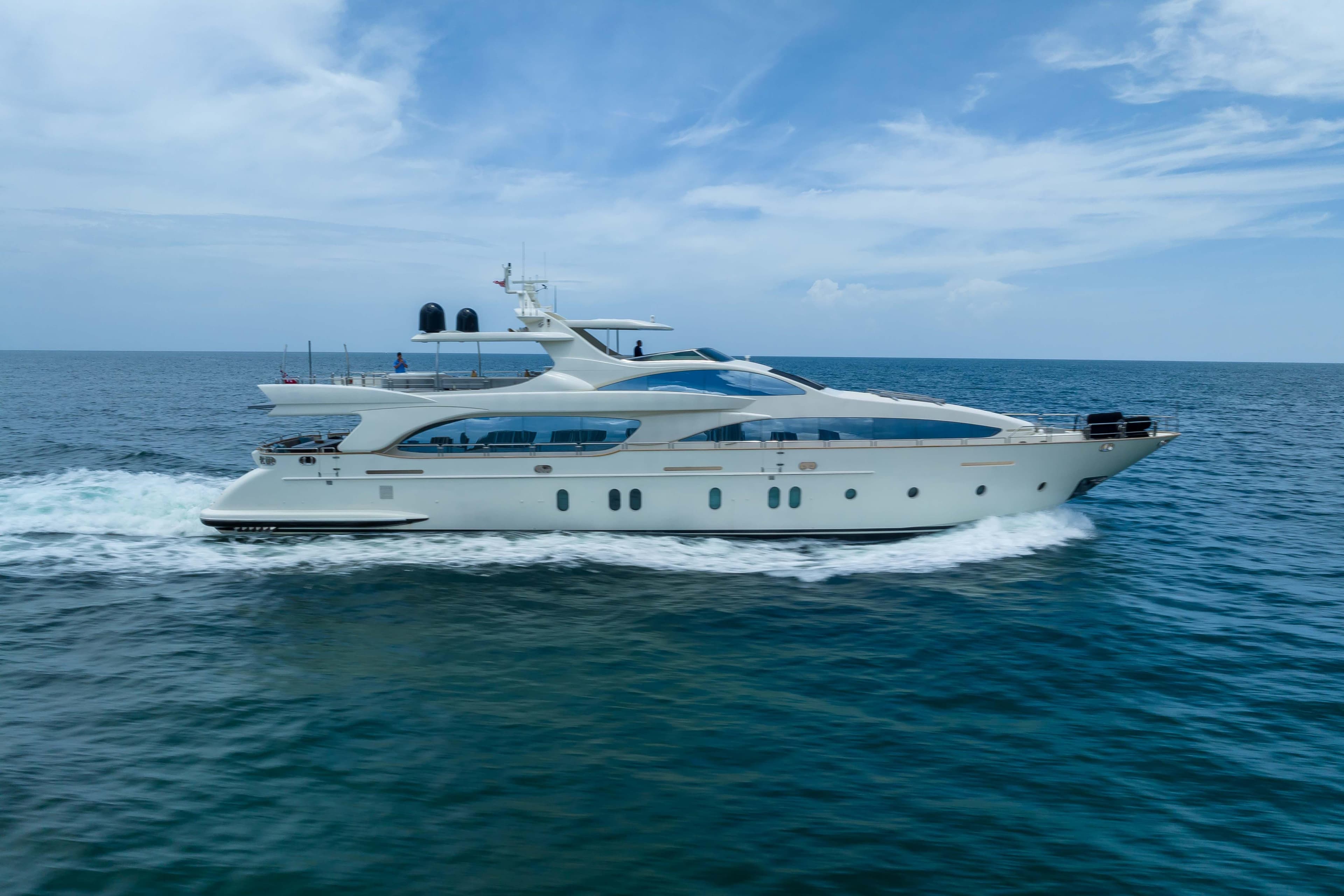Luxurious 2012 Azimut yacht cruising on open sea under clear blue sky.