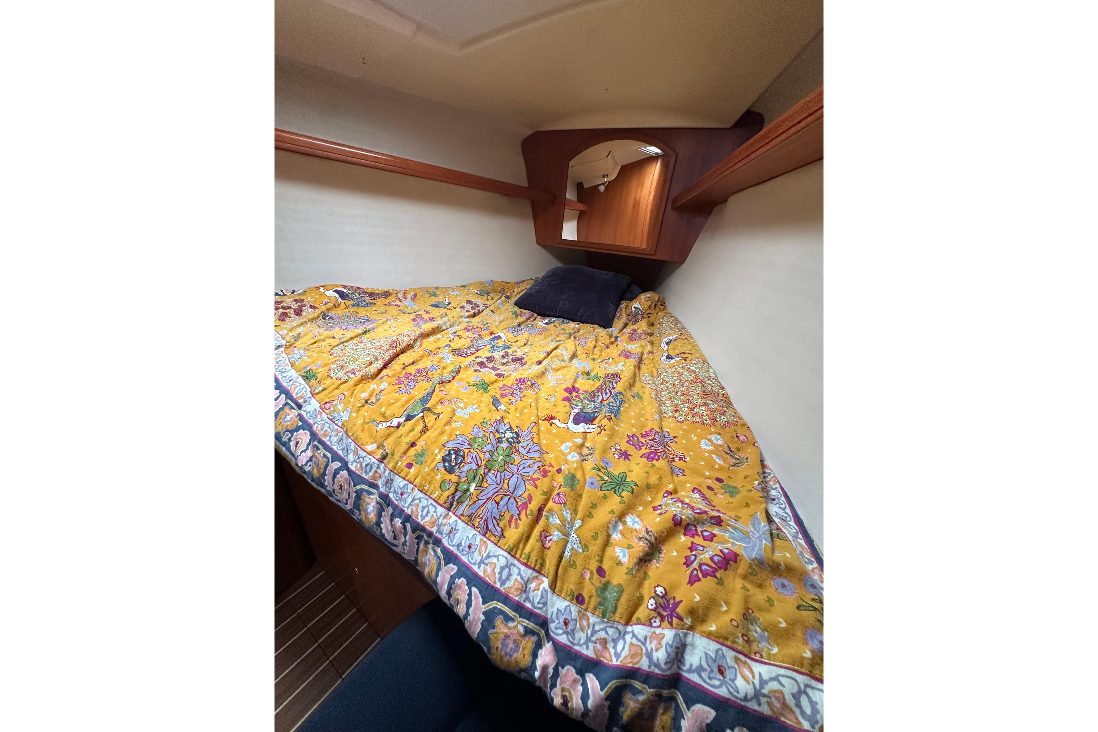 Cozy cabin interior of 2003 Hunter 426 Deck Salon with vibrant floral bedding.