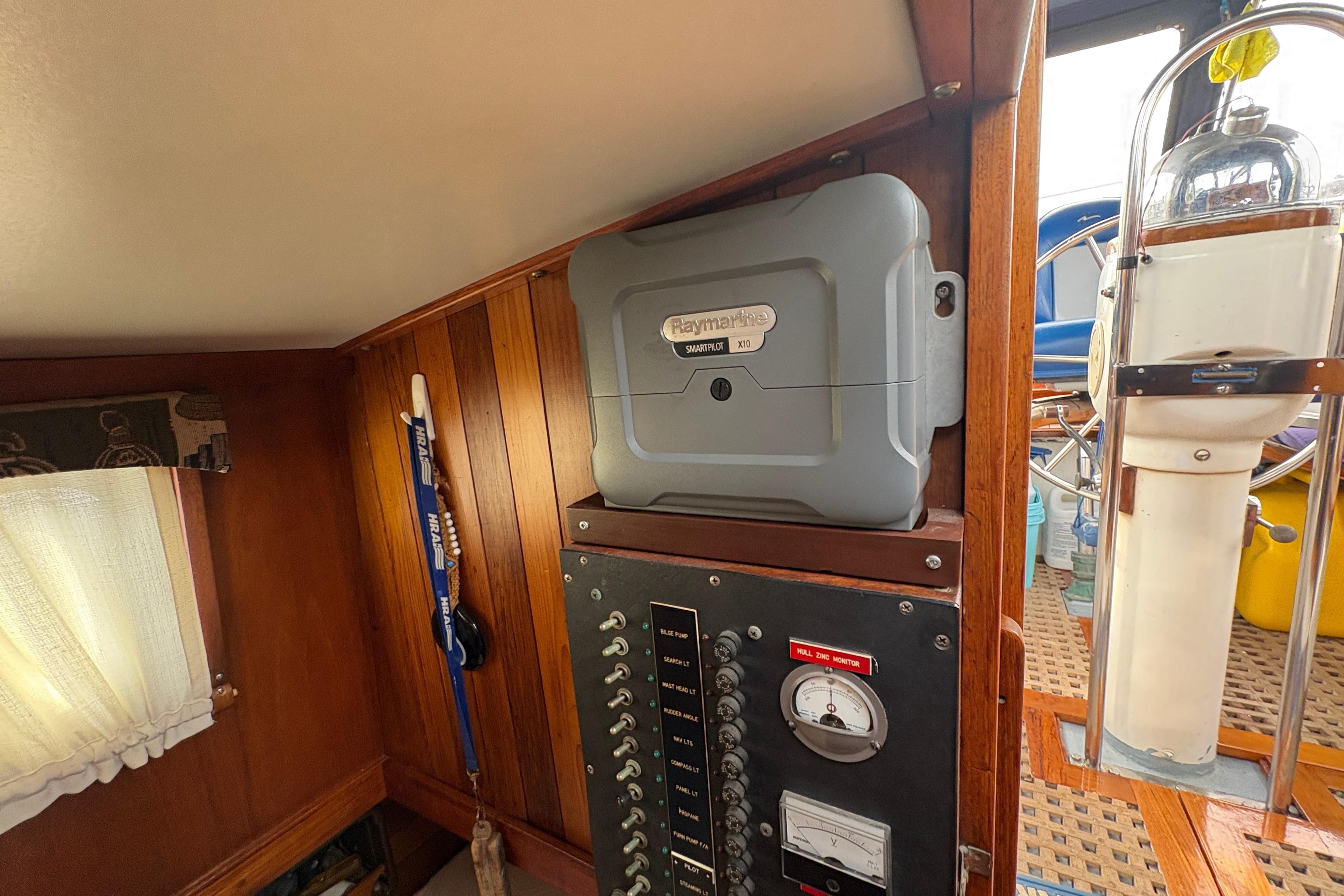 Interior of 1977 Folkes Full Keel Offshore Cutter with Raymarine autopilot and control panel.