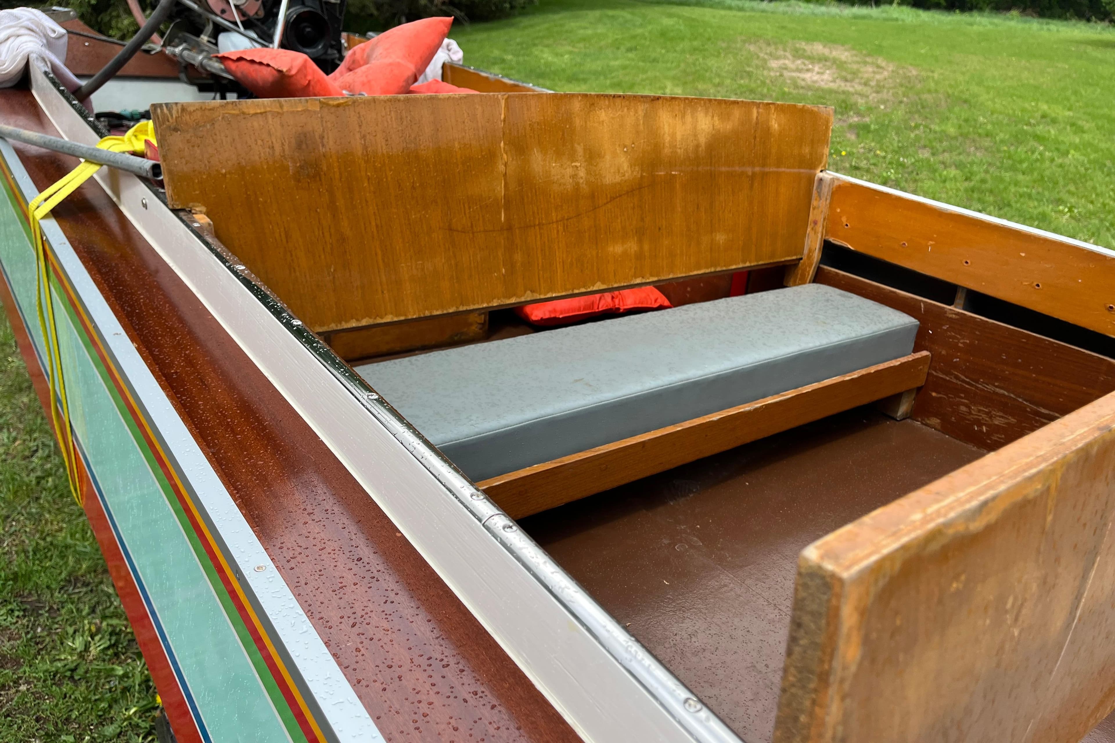 1990 Thai Longboat utility model with wooden seating and colorful exterior design.