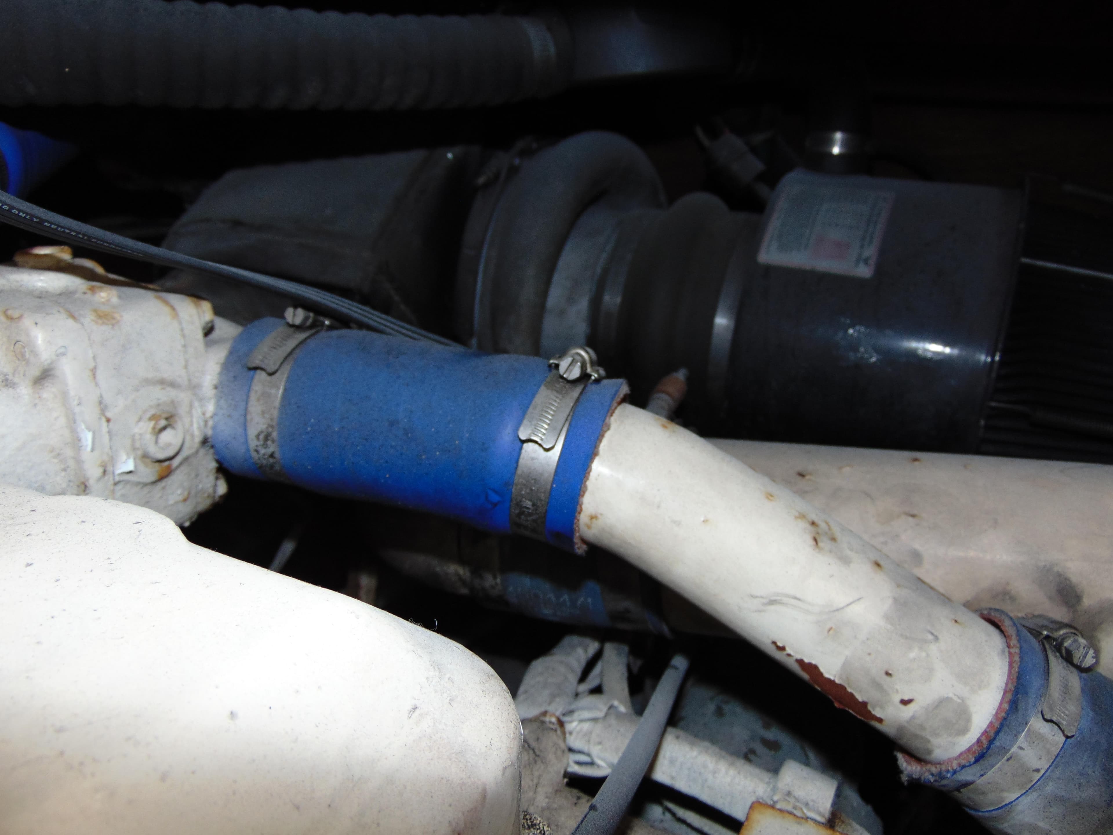 Engine components of a 1981 Post 46 Sportfish boat, featuring hoses and clamps.