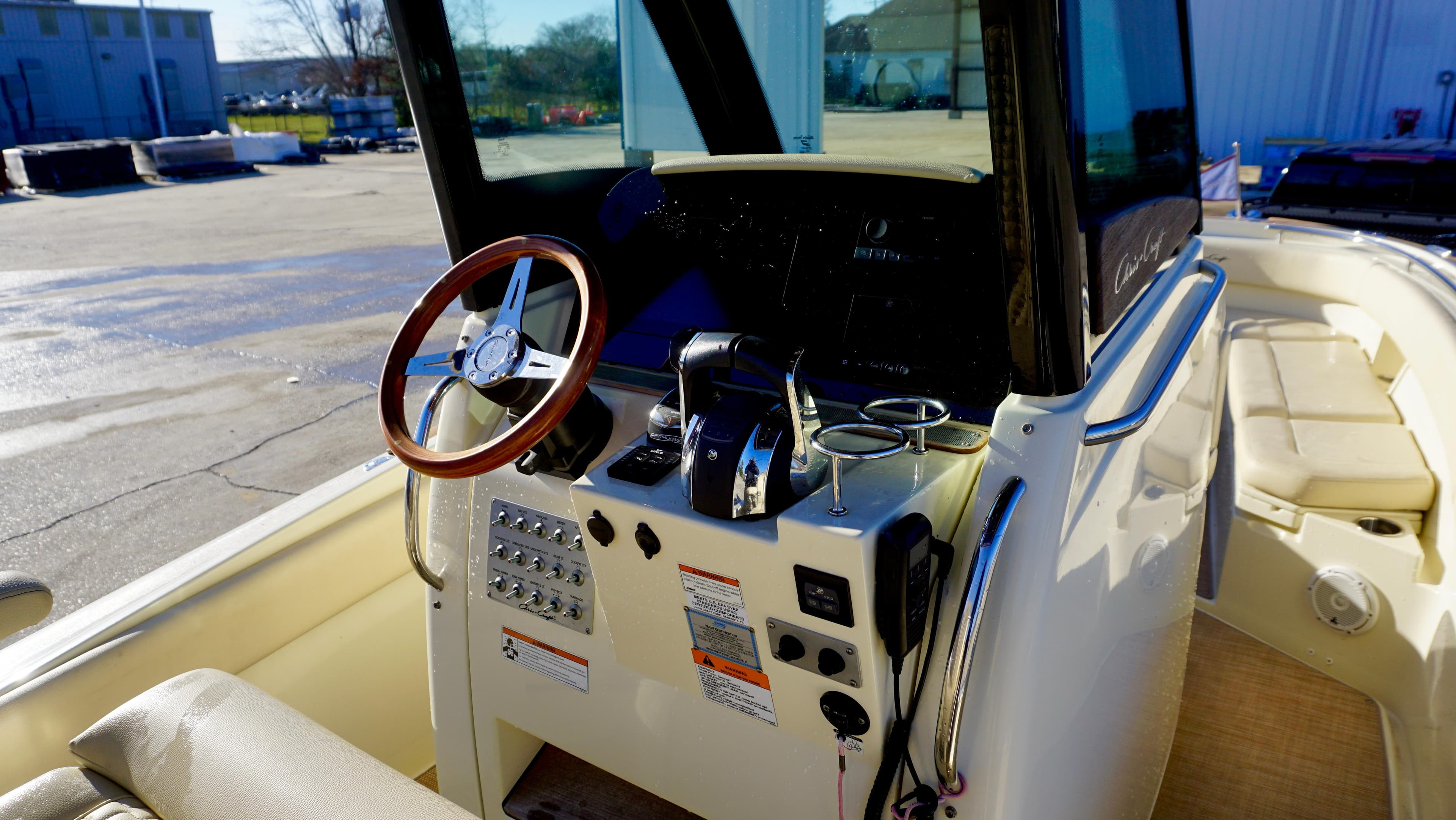 2021 Chris-Craft Catalina 27 helm with steering wheel and control panel.